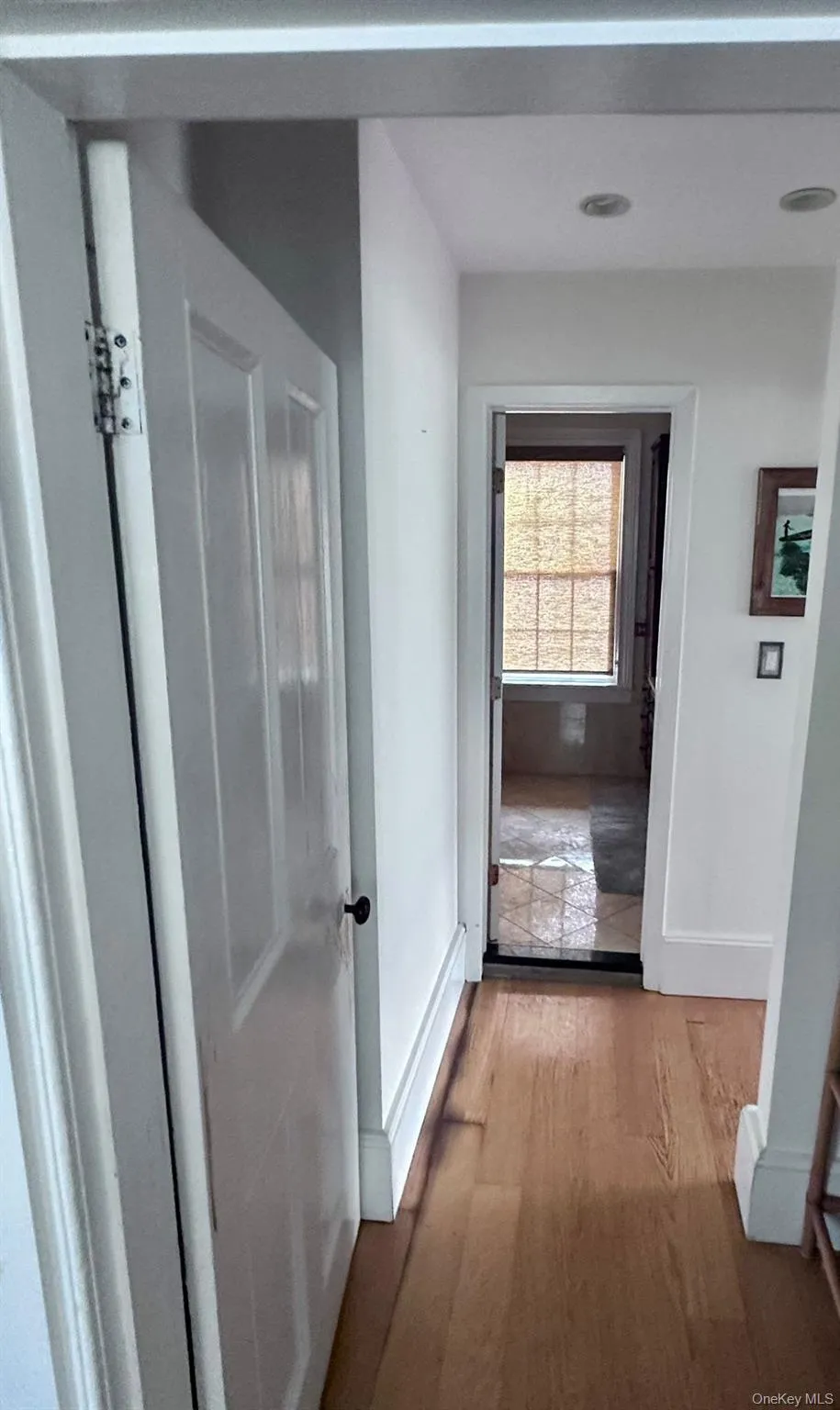 Corridor with wood finished floors and baseboards Corridor with wood finished floors and baseboards