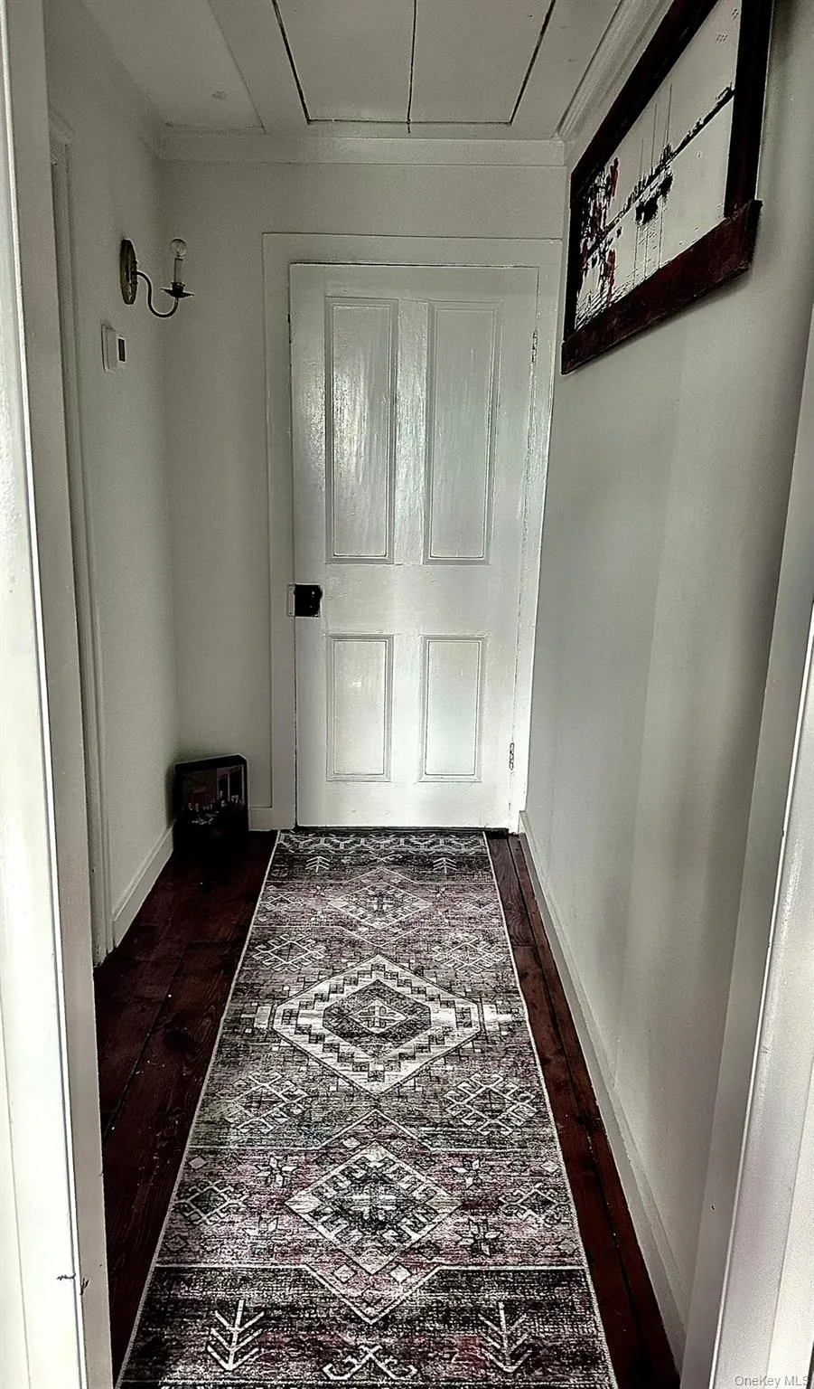 Doorway to outside featuring wood finished floors Doorway to outside featuring wood finished floors