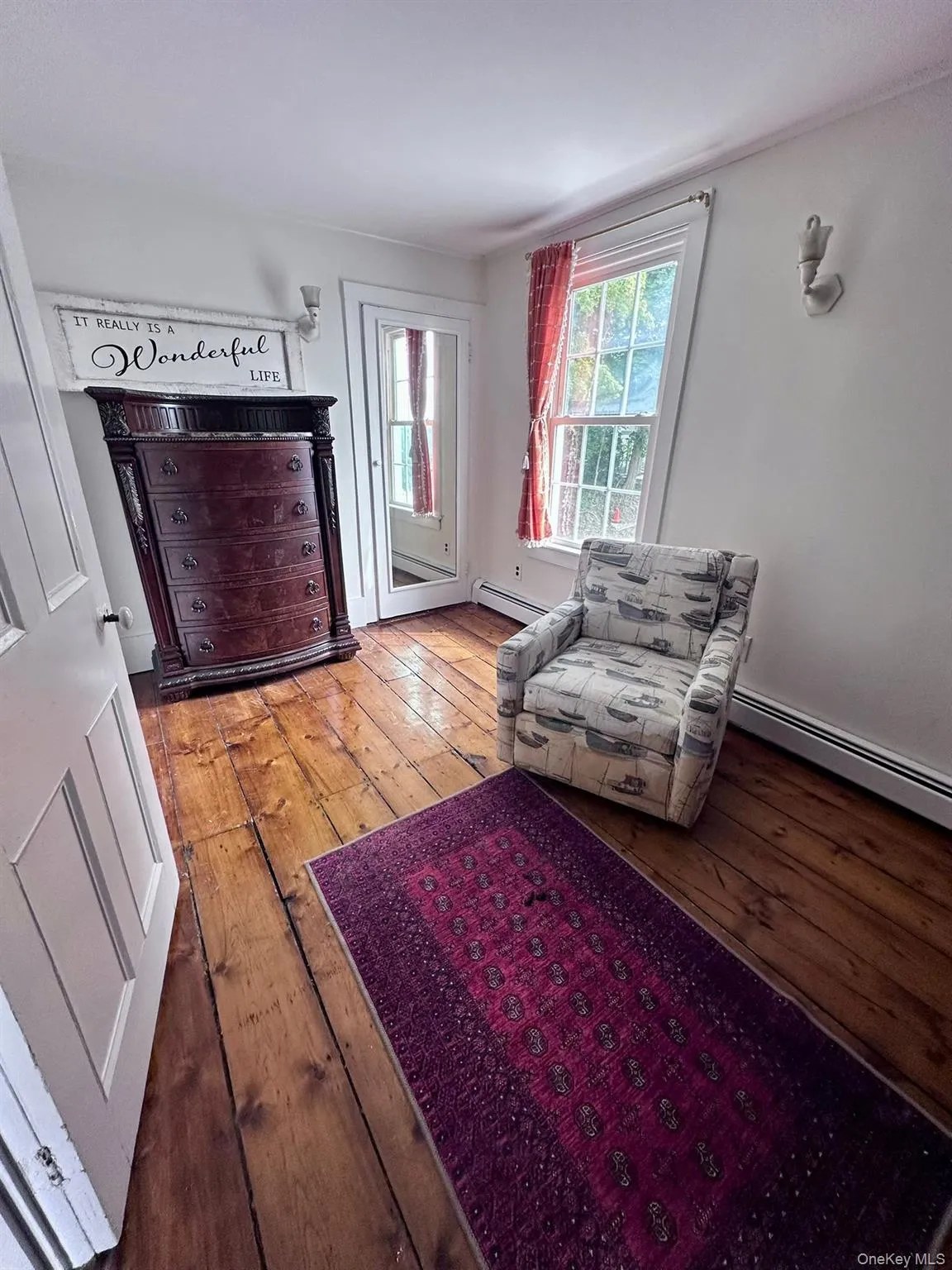 Sitting room with a baseboard radiator and light wood-style flooring Sitting room with a baseboard radiator and light wood-style flooring