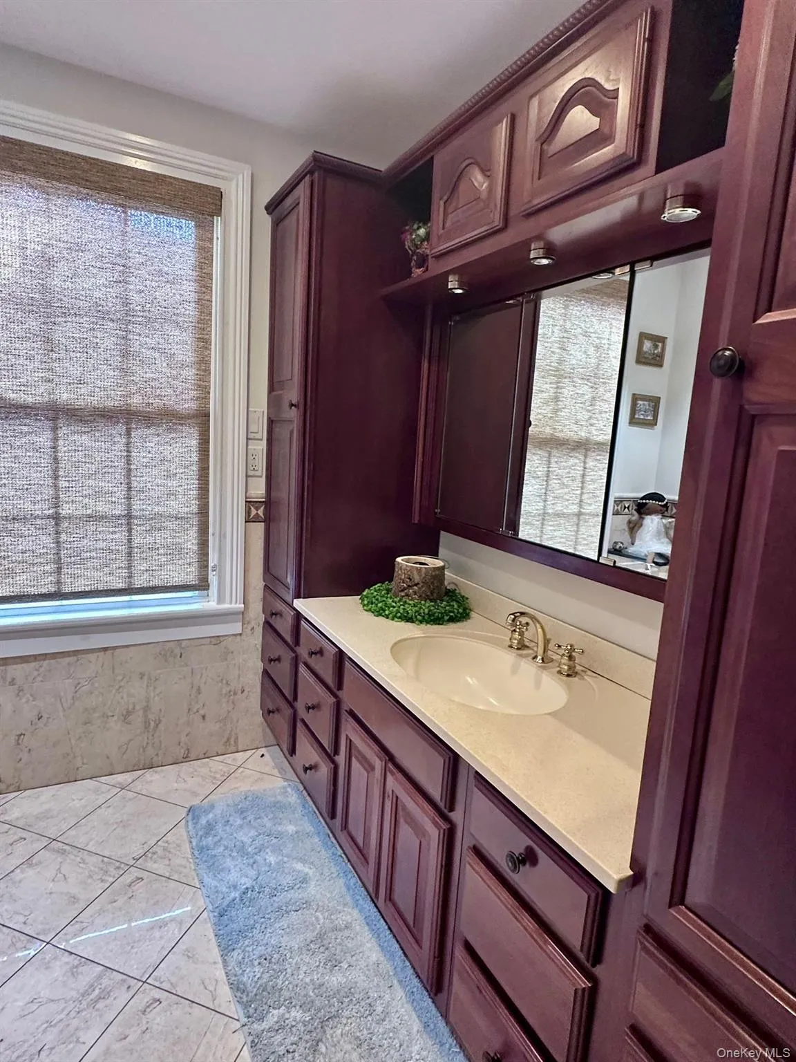 Bathroom with vanity and light tile patterned floors Bathroom with vanity and light tile patterned floors