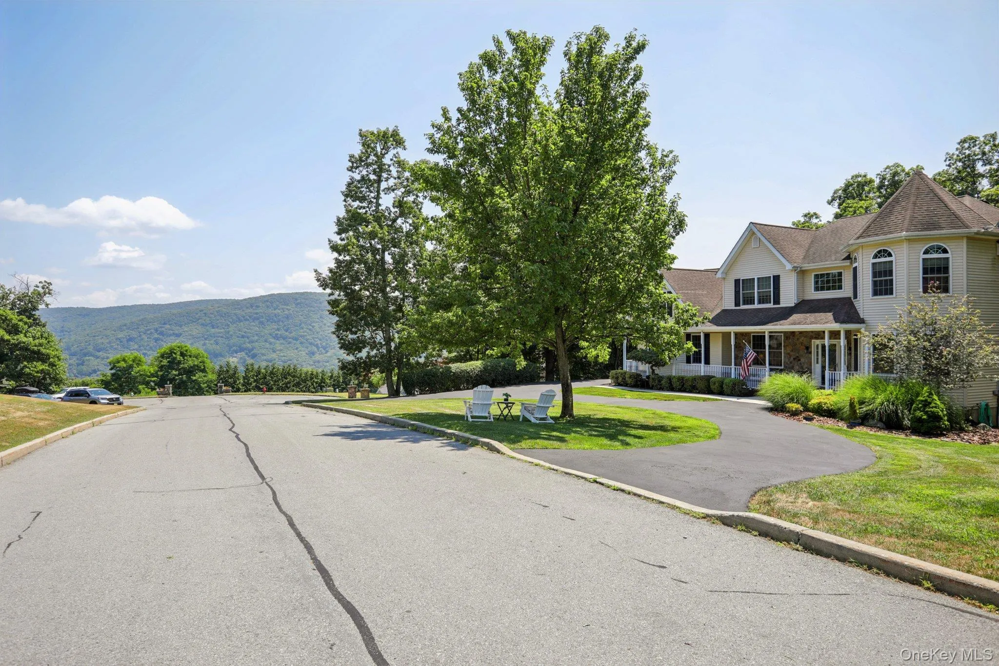 View of asphalt street featuring curbs and a mountain view View of asphalt street featuring curbs and a mountain view
