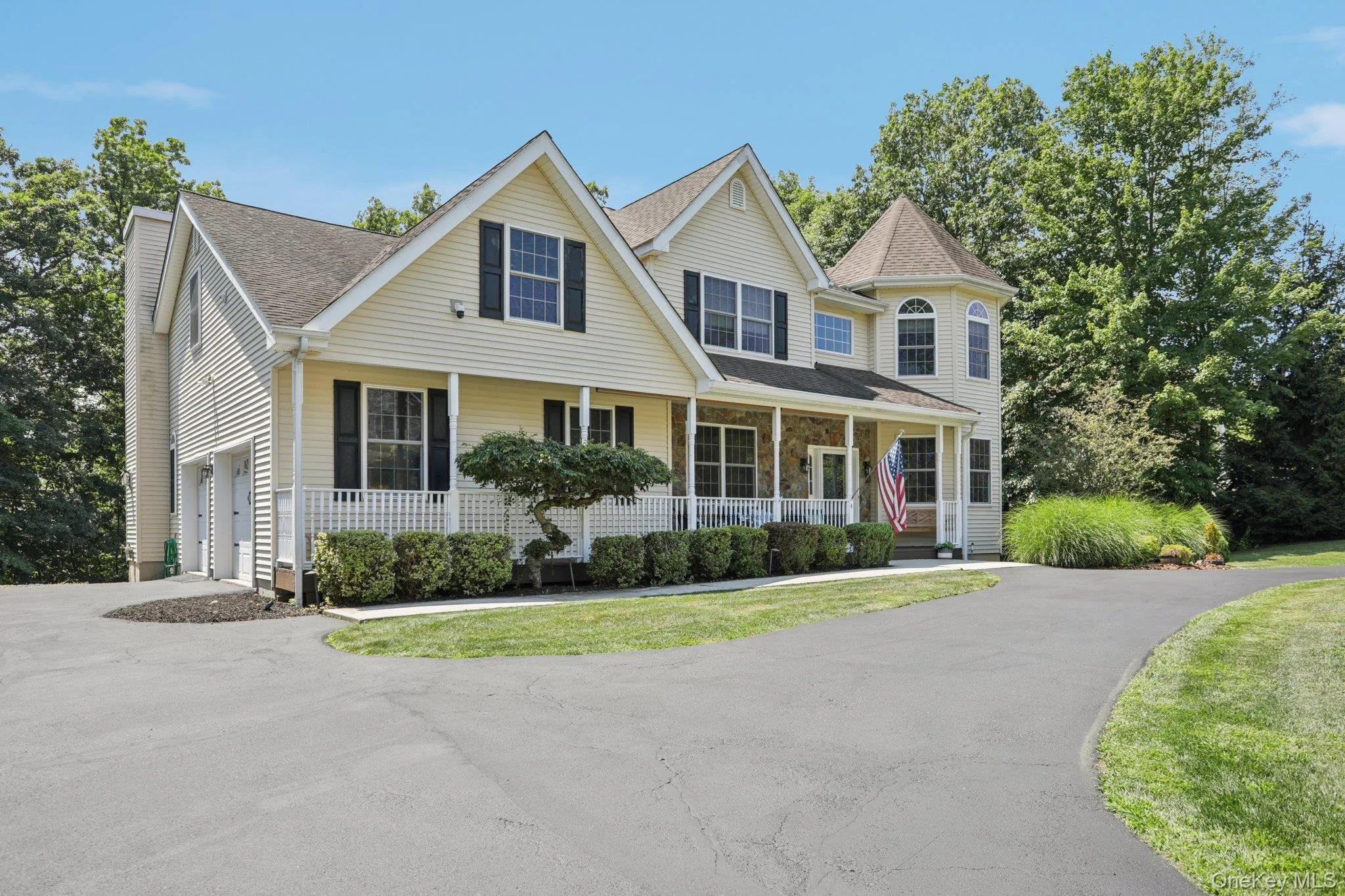 View of front of home with a porch, a garage, a shingled roof, and asphalt driveway View of front of home with a porch, a garage, a shingled roof, and asphalt driveway