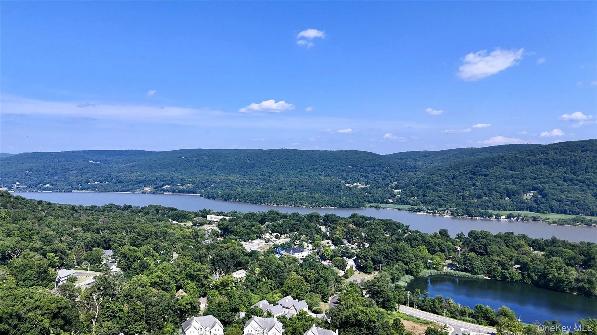 Aerial view of a large body of water and a heavily wooded area Aerial view of a large body of water and a heavily wooded area