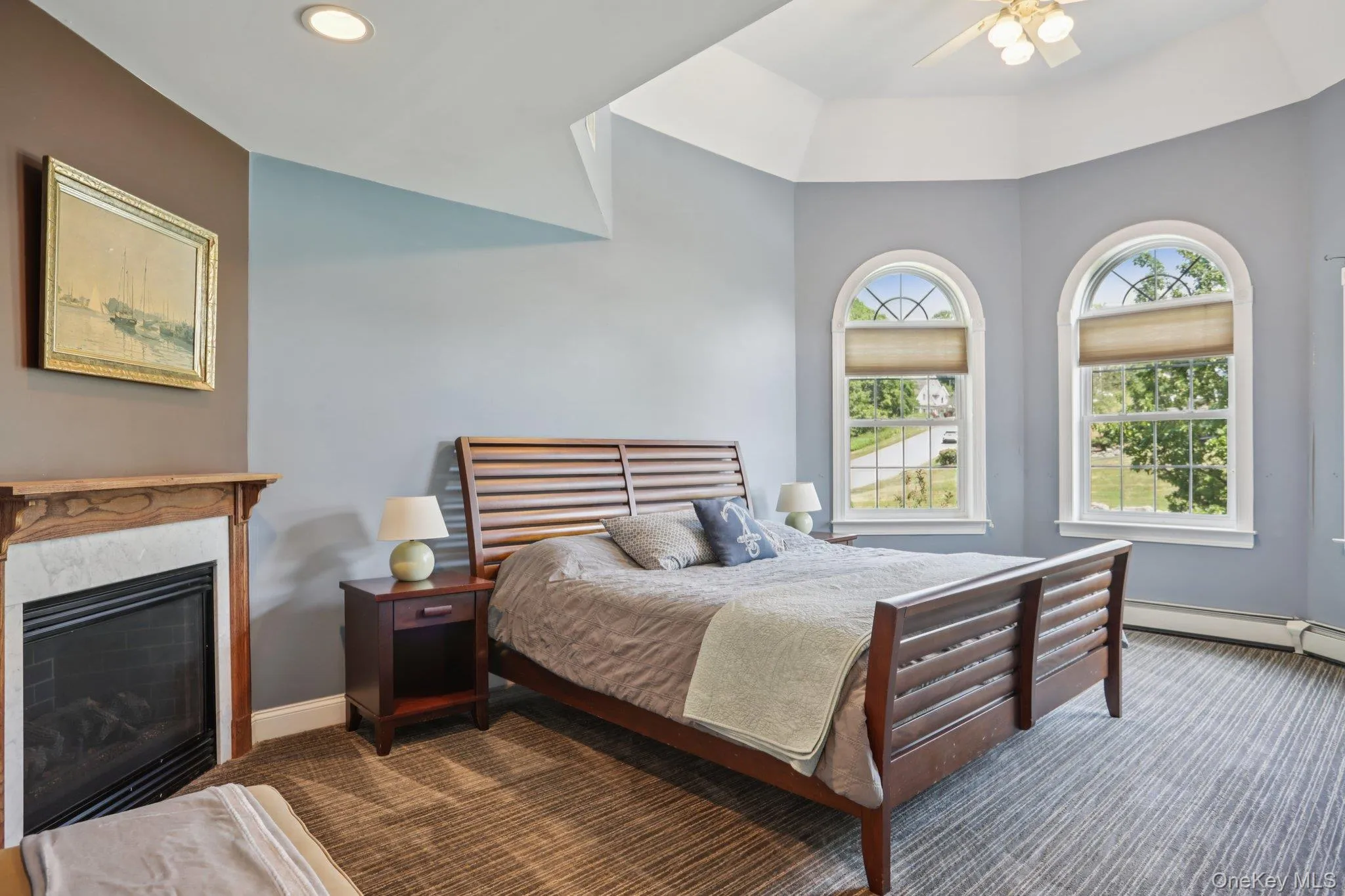 Bedroom with carpet floors, a ceiling fan, recessed lighting, and a fireplace Bedroom with carpet floors, a ceiling fan, recessed lighting, and a fireplace