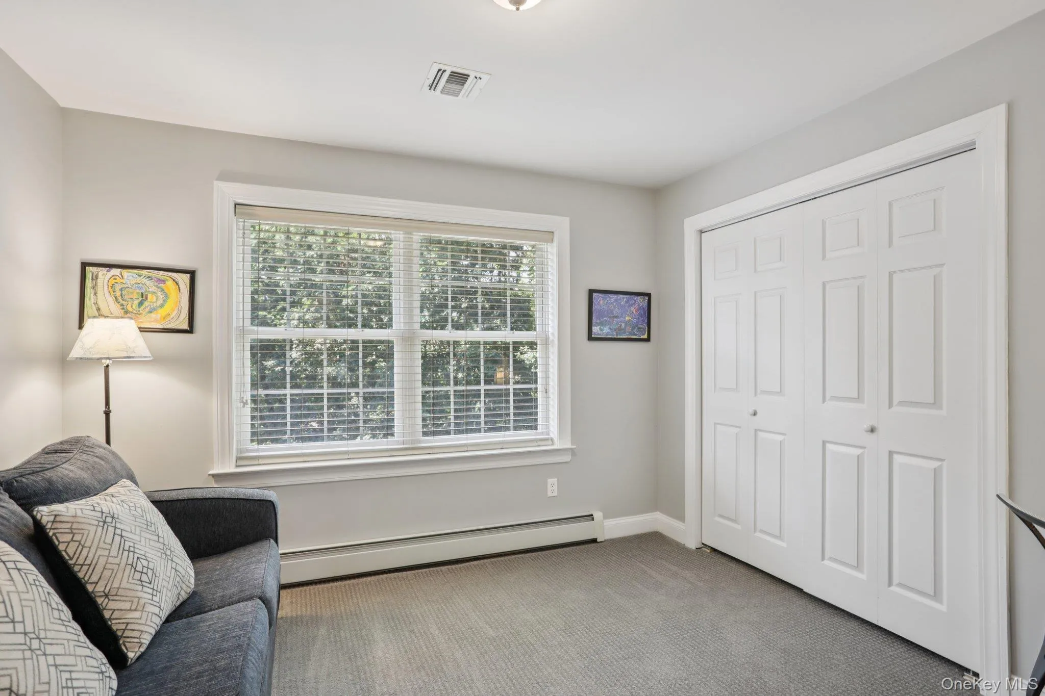 Bedroom featuring carpet and a baseboard radiator Bedroom featuring carpet and a baseboard radiator