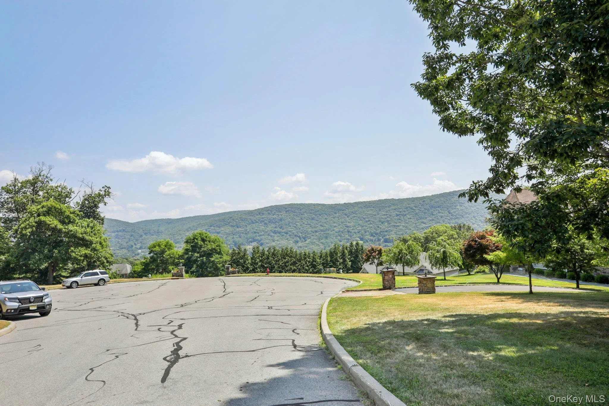 View of asphalt road with a mountain view and curbs View of asphalt road with a mountain view and curbs