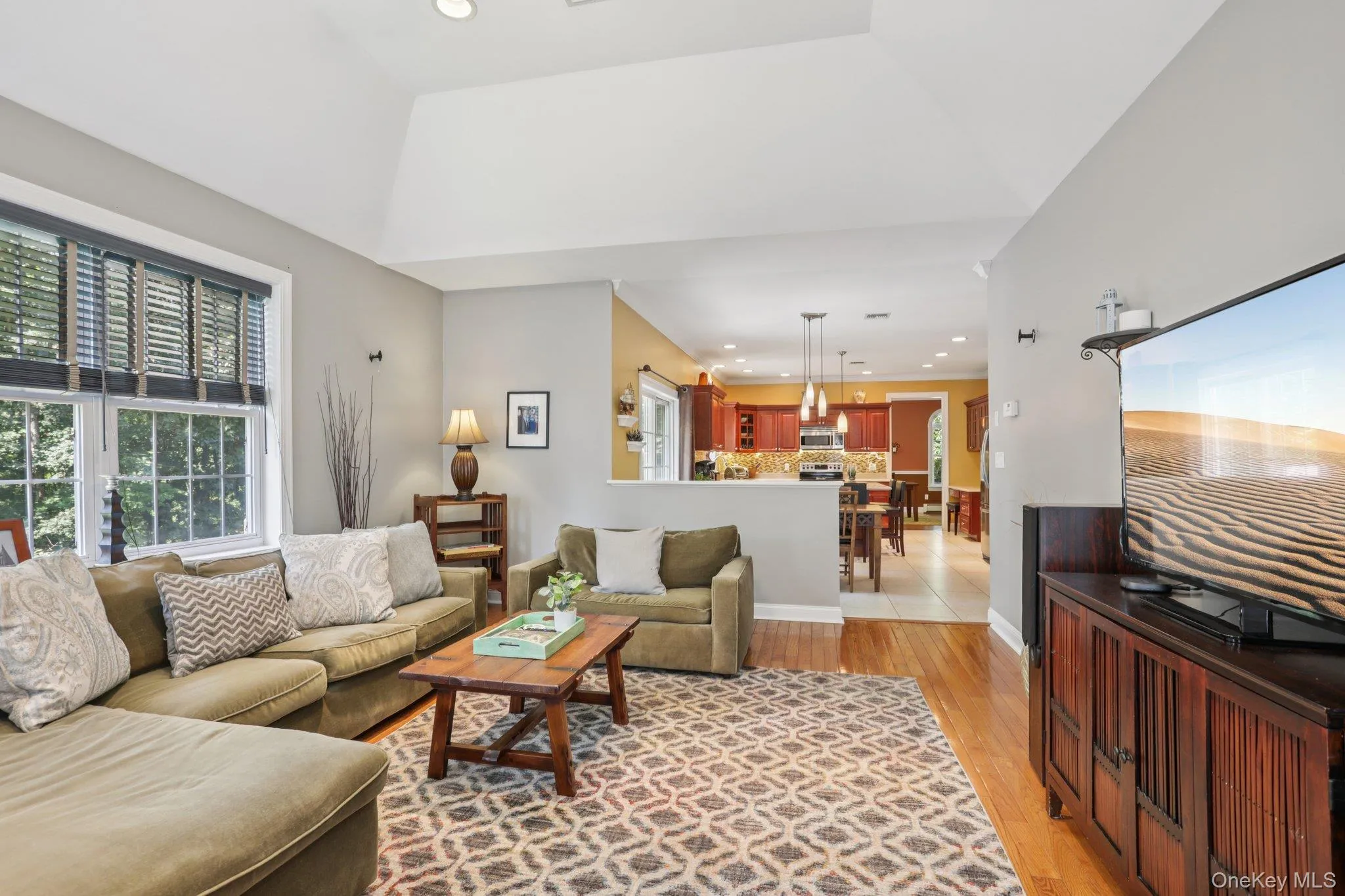 Living room featuring recessed lighting, plenty of natural light, and light wood-type flooring Living room featuring recessed lighting, plenty of natural light, and light wood-type flooring