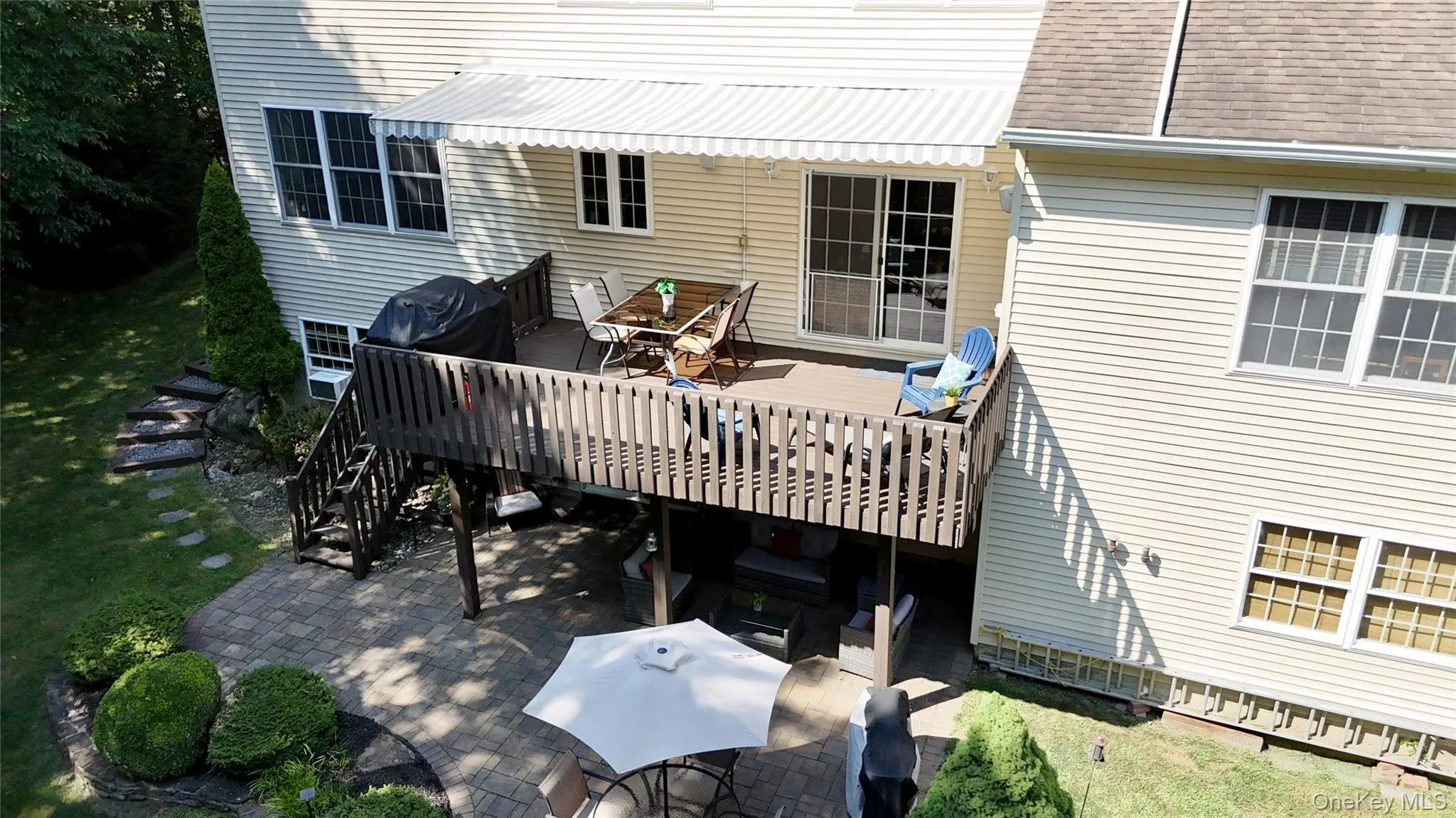 Wooden deck featuring outdoor dining space and a patio Wooden deck featuring outdoor dining space and a patio