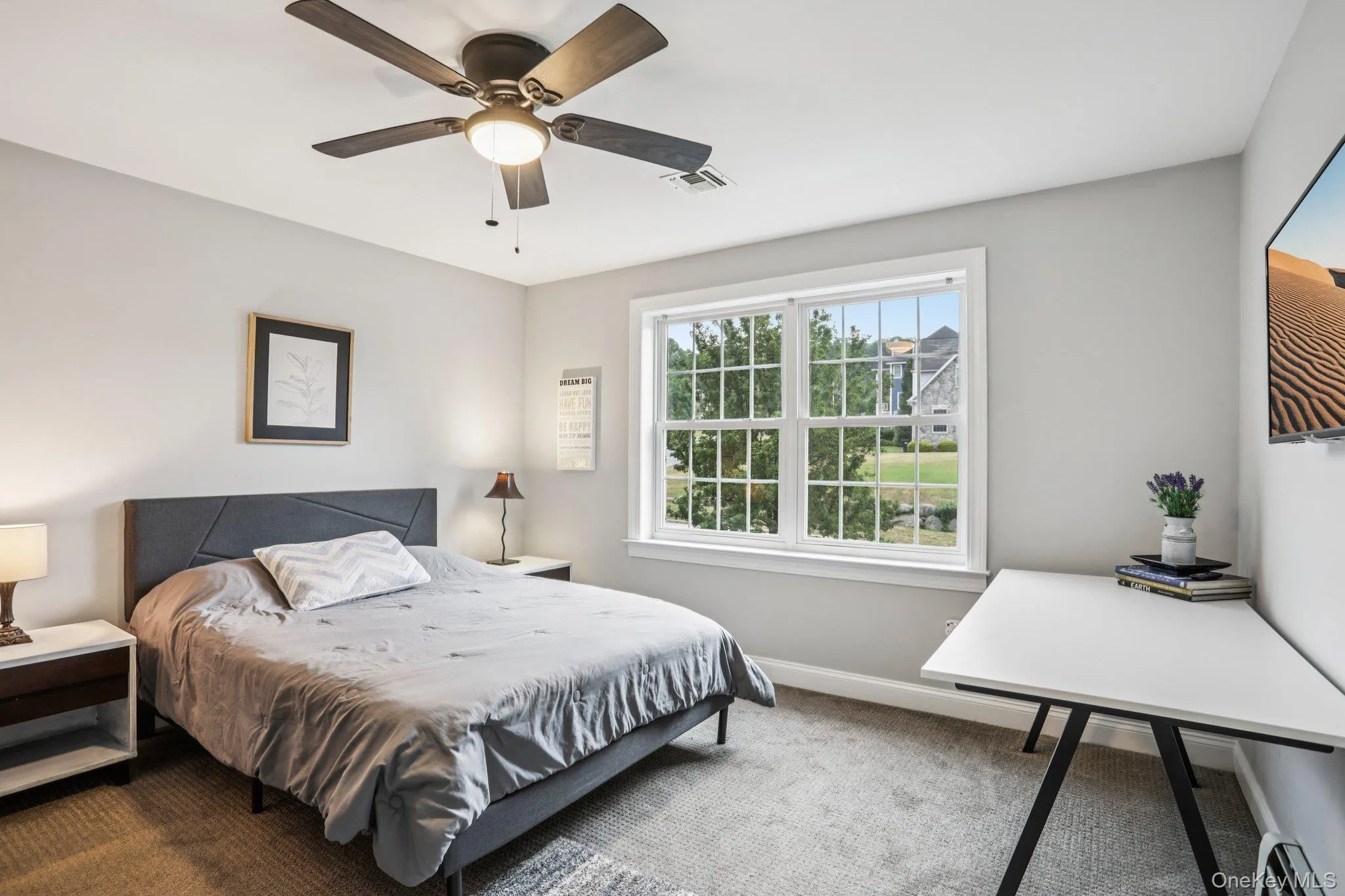 Carpeted bedroom with a baseboard heating unit and a ceiling fan Carpeted bedroom with a baseboard heating unit and a ceiling fan