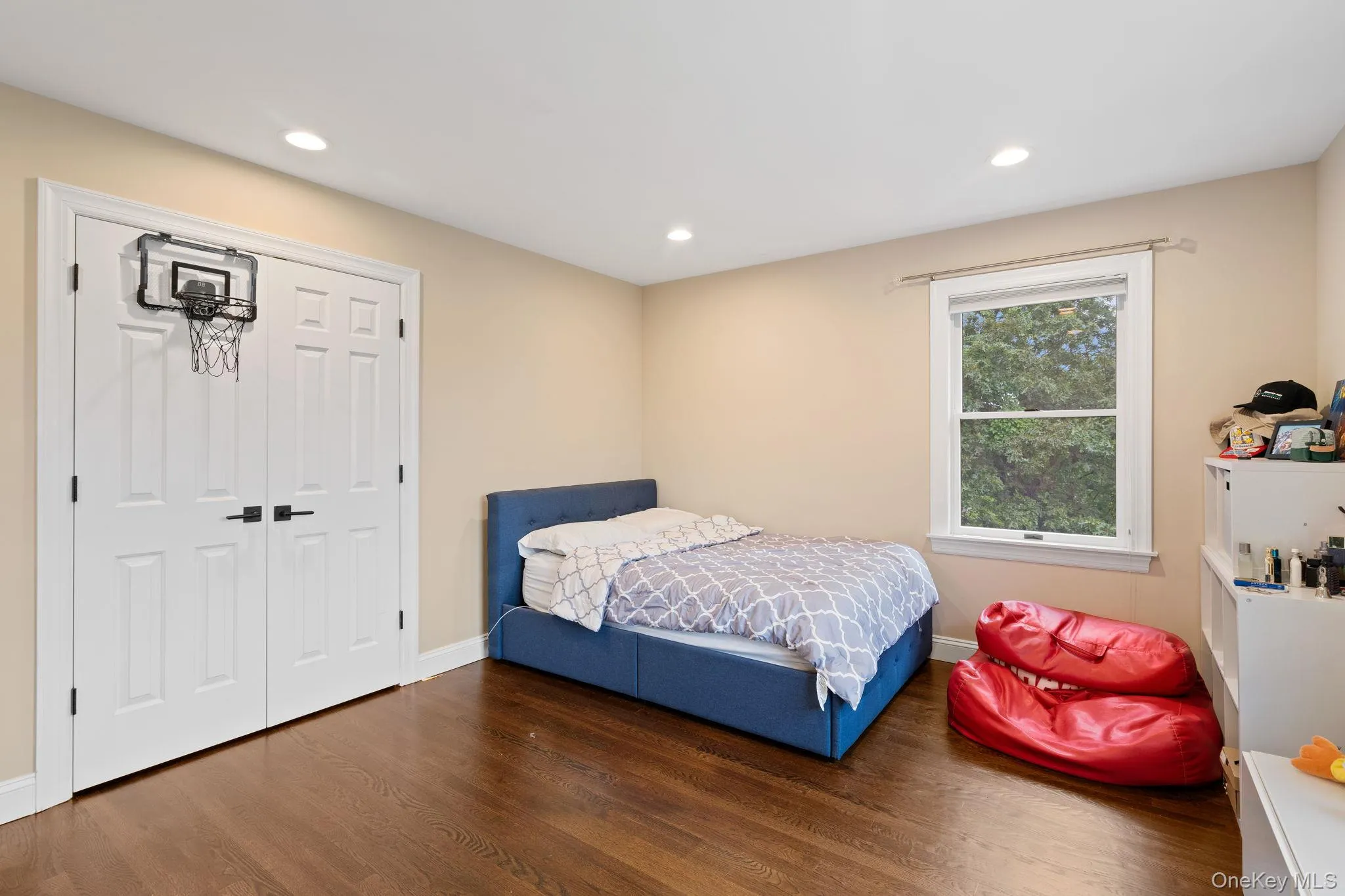 Bedroom featuring wood finished floors, recessed lighting, and a closet Bedroom featuring wood finished floors, recessed lighting, and a closet