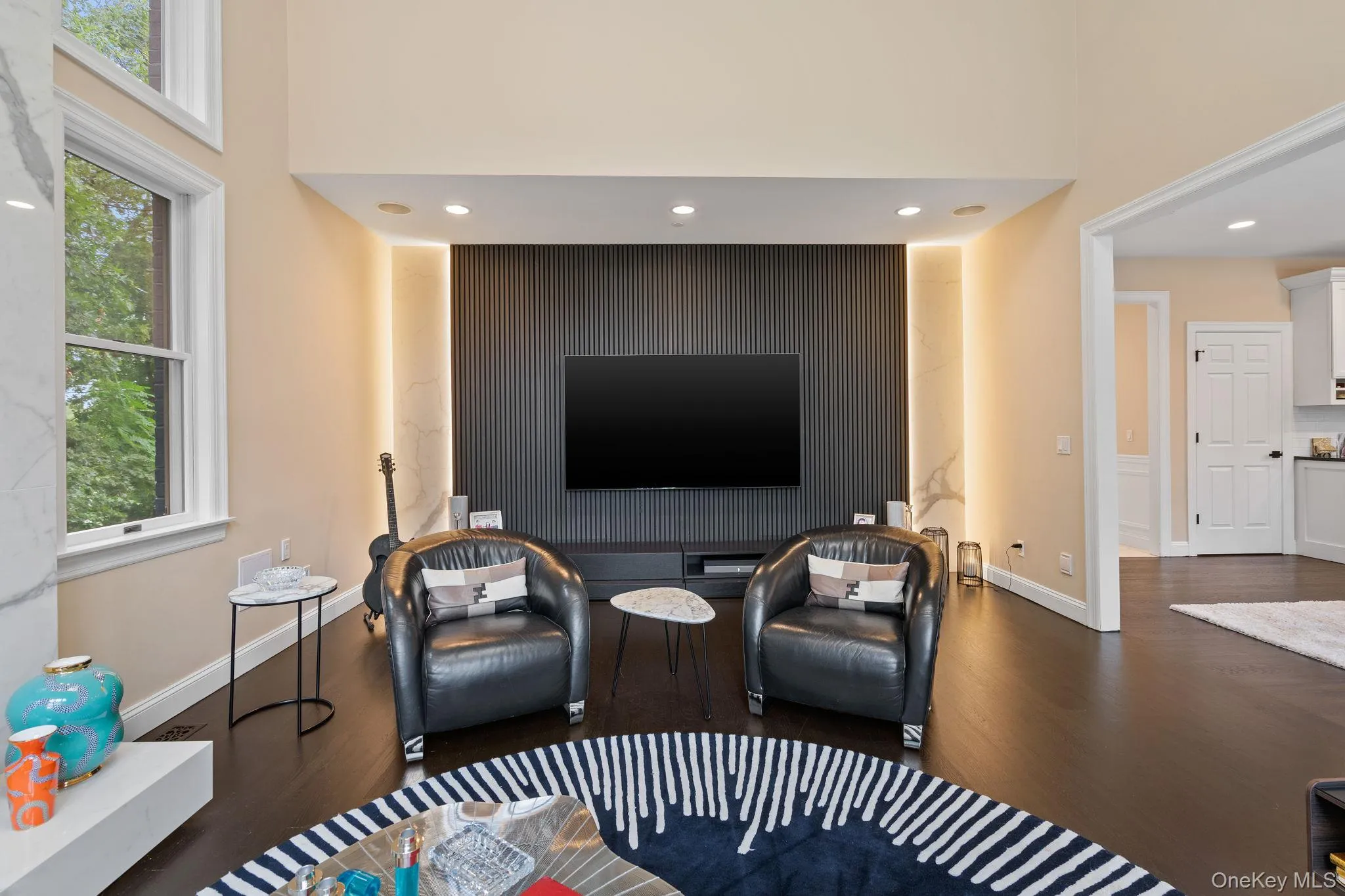 Living room with recessed lighting, dark wood-type flooring, and healthy amount of natural light Living room with recessed lighting, dark wood-type flooring, and healthy amount of natural light