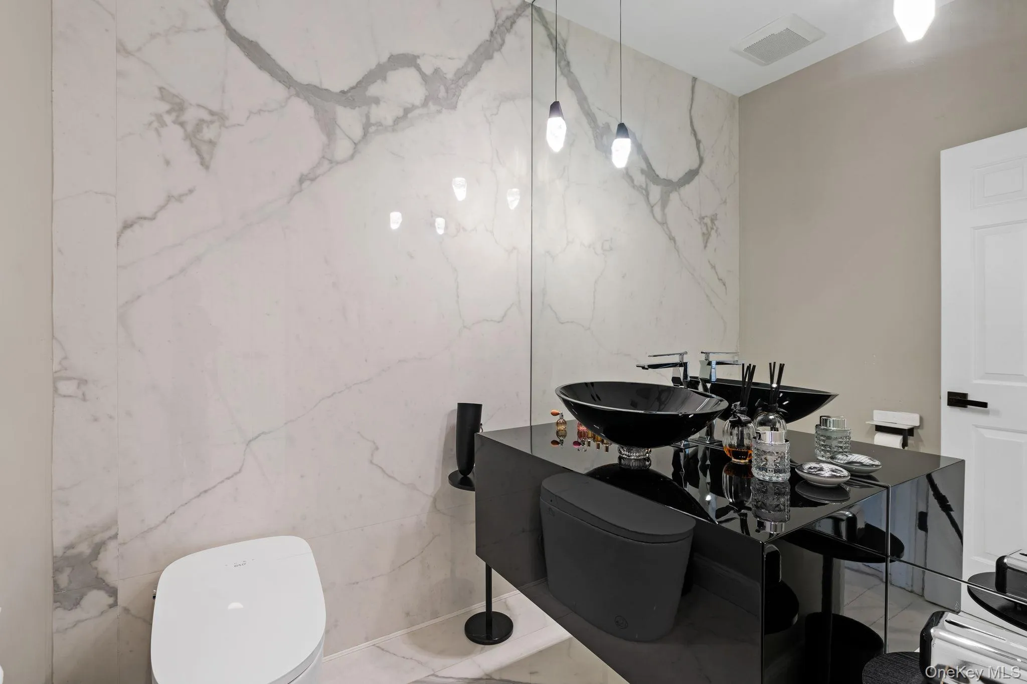 Bathroom with stone wall and marble tiled flooring Bathroom with stone wall and marble tiled flooring