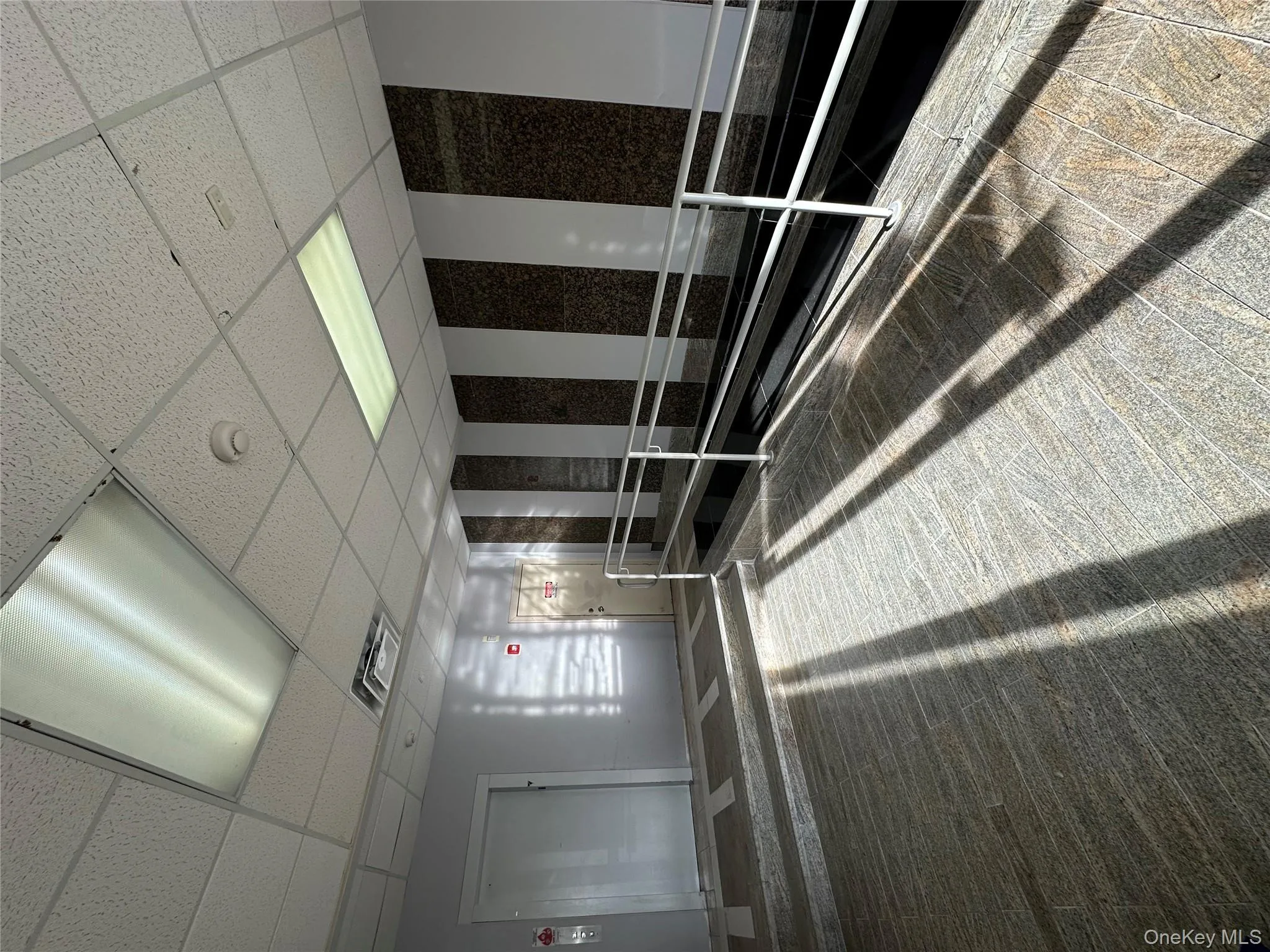 Building lobby featuring a paneled ceiling Building lobby featuring a paneled ceiling