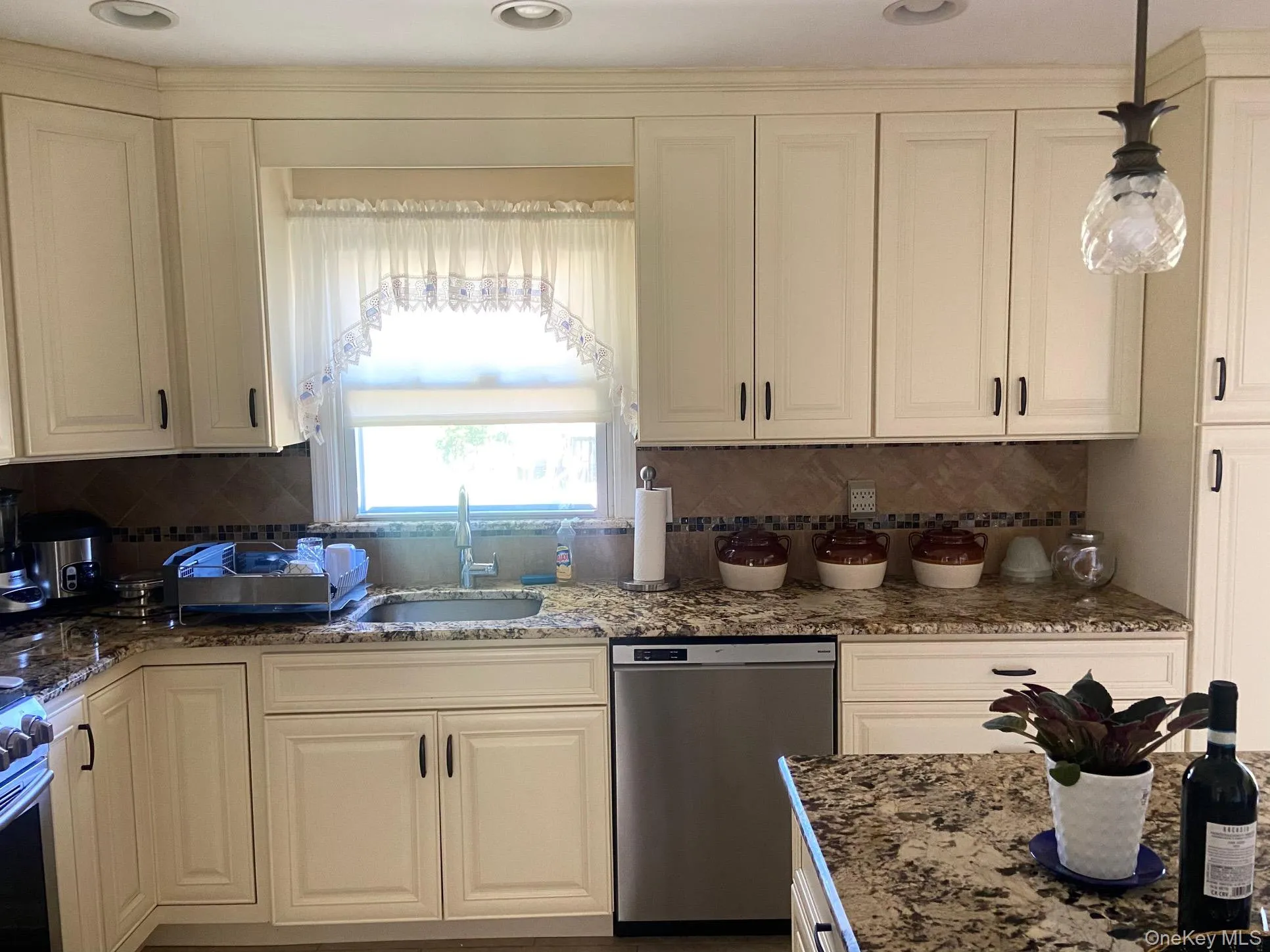 Kitchen featuring appliances with stainless steel finishes, dark stone countertops, tasteful backsplash, decorative light fixtures, and recessed lighting Kitchen featuring appliances with stainless steel finishes, dark stone countertops, tasteful backsplash, decorative light fixtures, and recessed lighting