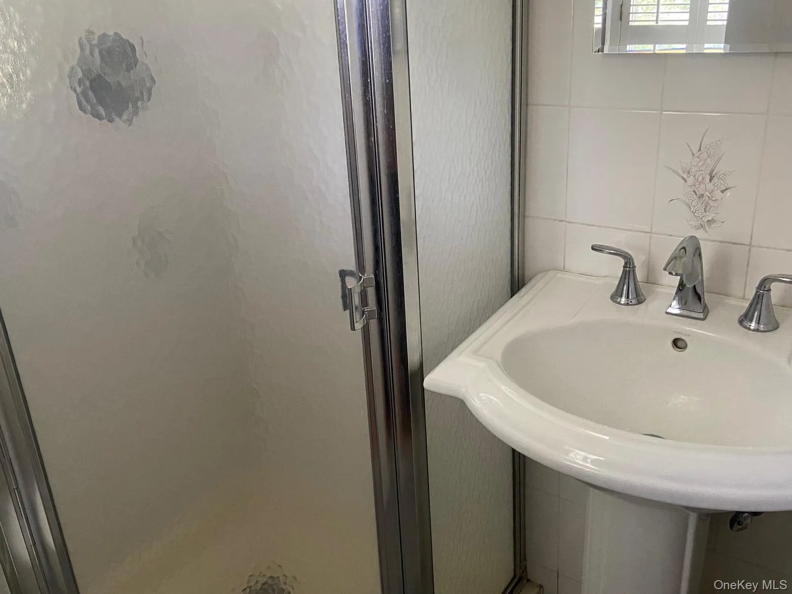 Bathroom with tile walls and a shower stall in primary bedroom Bathroom with tile walls and a shower stall in primary bedroom