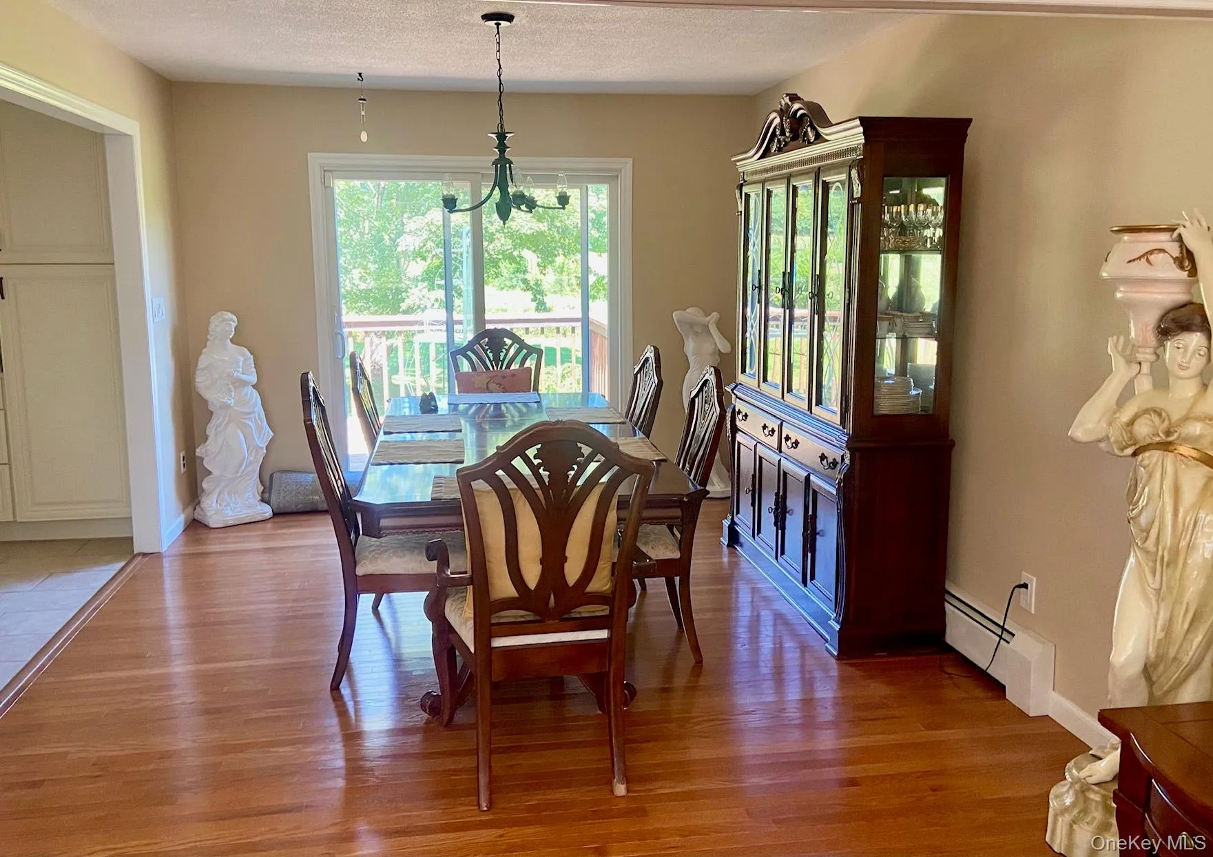 Dining room featuring light wood finished floors, and sliders to deck Dining room featuring light wood finished floors, and sliders to deck