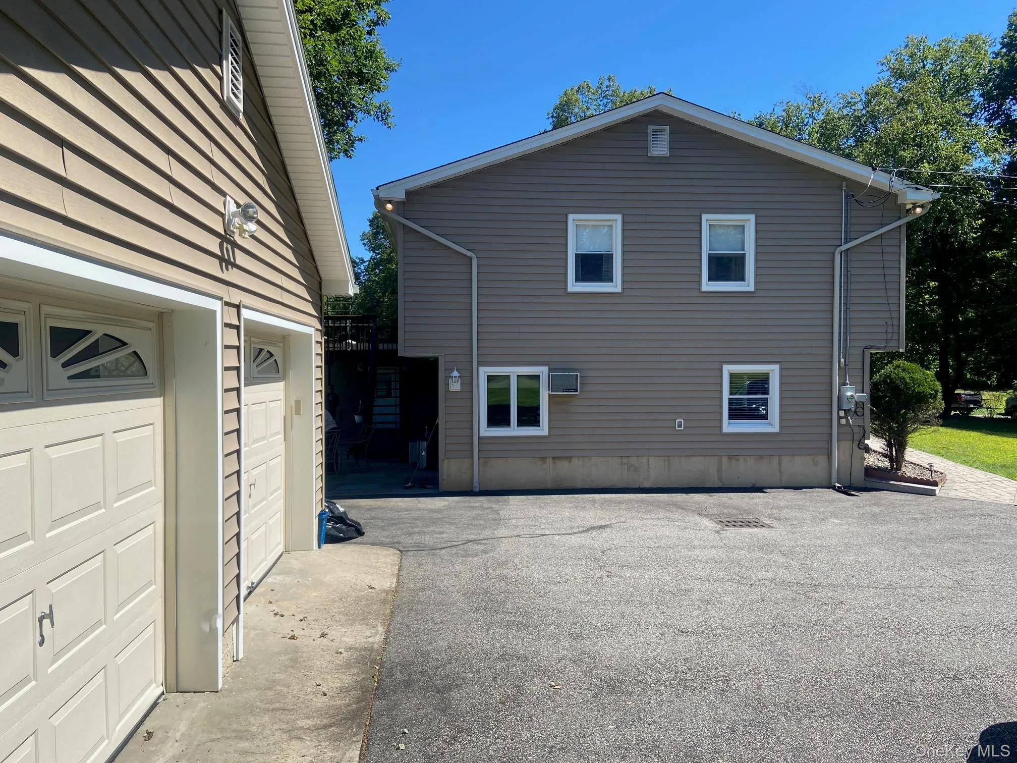 View of home's exterior with driveway and garage View of home's exterior with driveway and garage