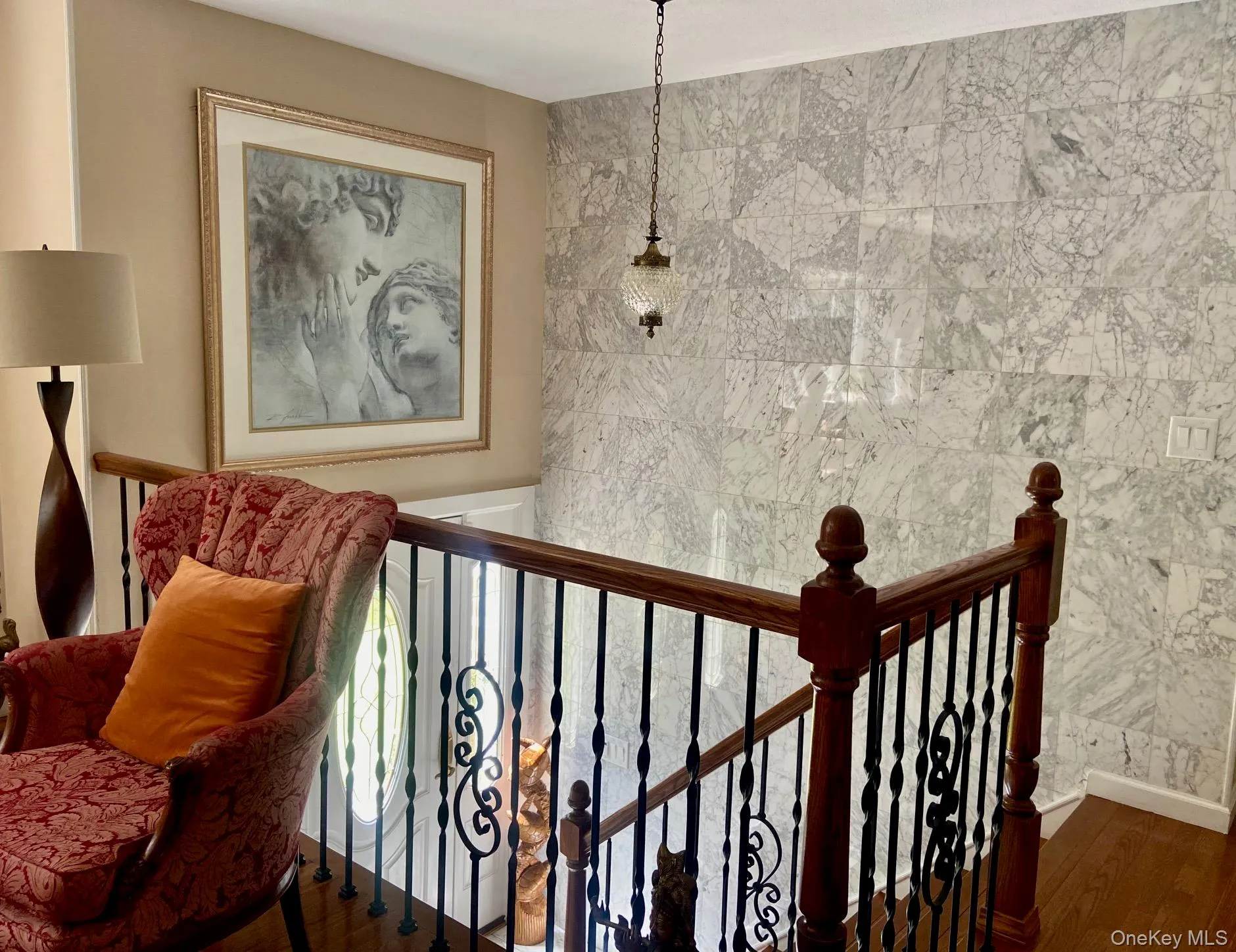 Staircase featuring wood finished floors and tile walls Staircase featuring wood finished floors and tile walls