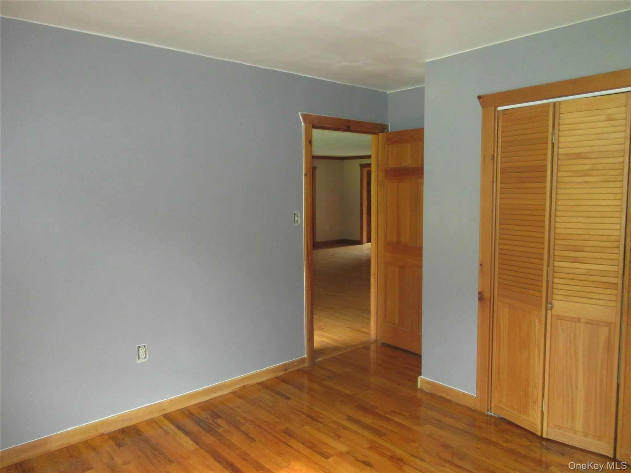 Unfurnished bedroom with light wood-style flooring and a closet Unfurnished bedroom with light wood-style flooring and a closet