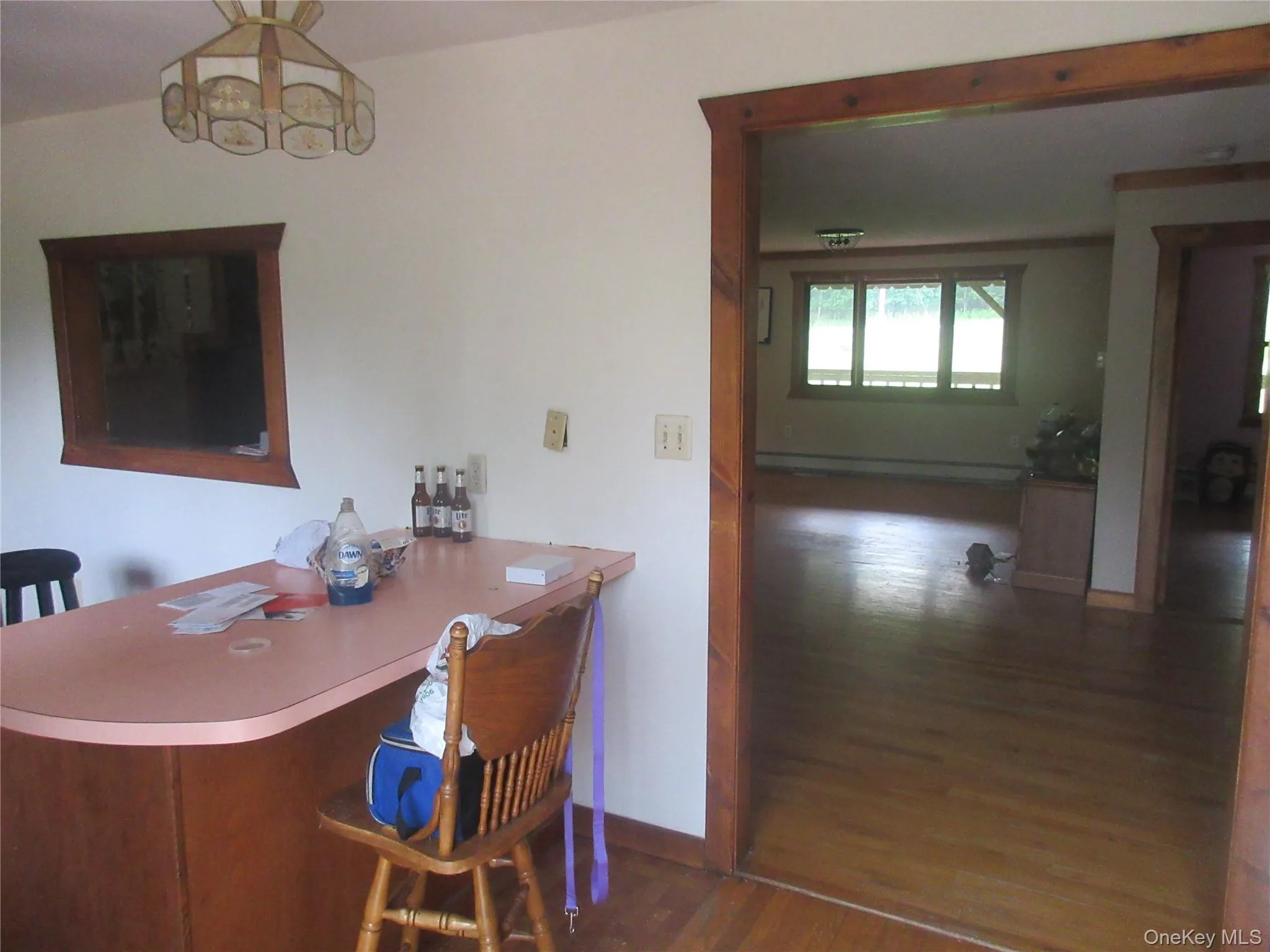 Dining space with wood finished floors and a baseboard radiator Dining space with wood finished floors and a baseboard radiator