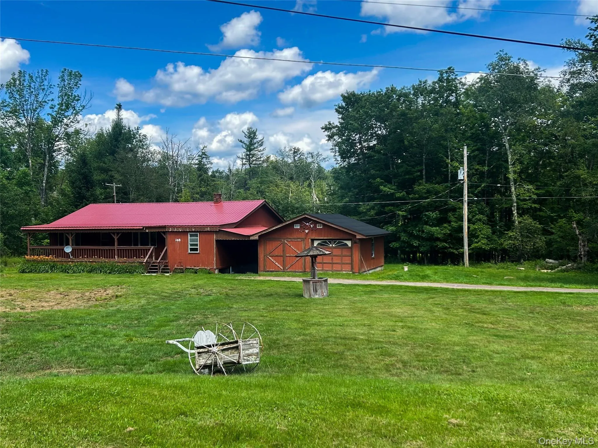 View of front of house with a front lawn and a metal roof View of front of house with a front lawn and a metal roof