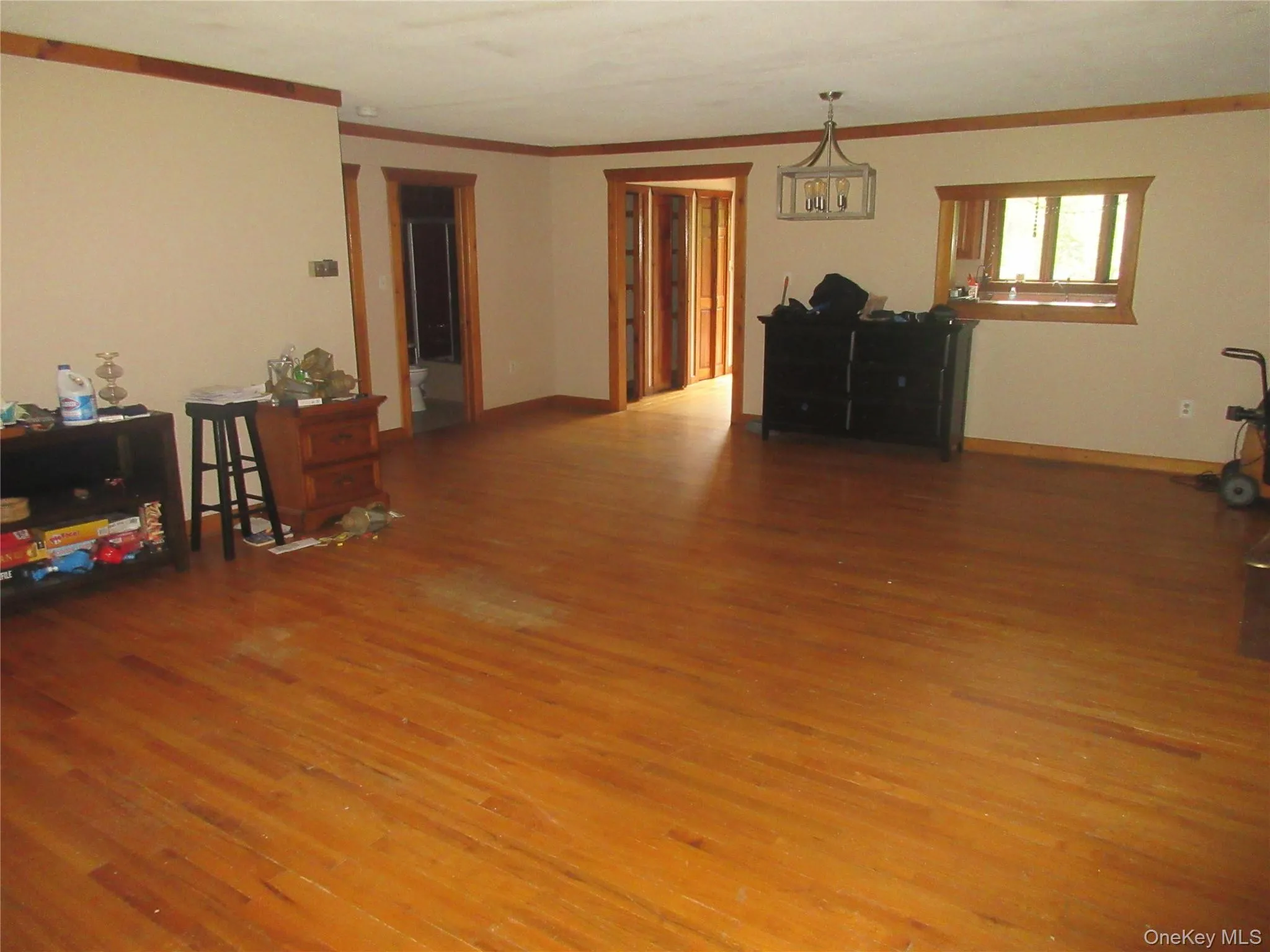 Living area with wood finished floors and crown molding Living area with wood finished floors and crown molding