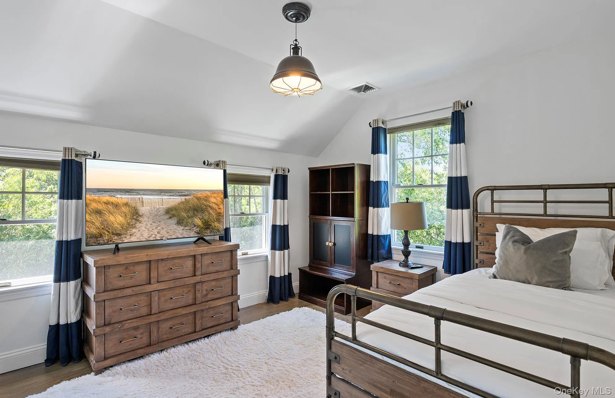 Bedroom with vaulted ceiling and dark wood-style floors Bedroom with vaulted ceiling and dark wood-style floors