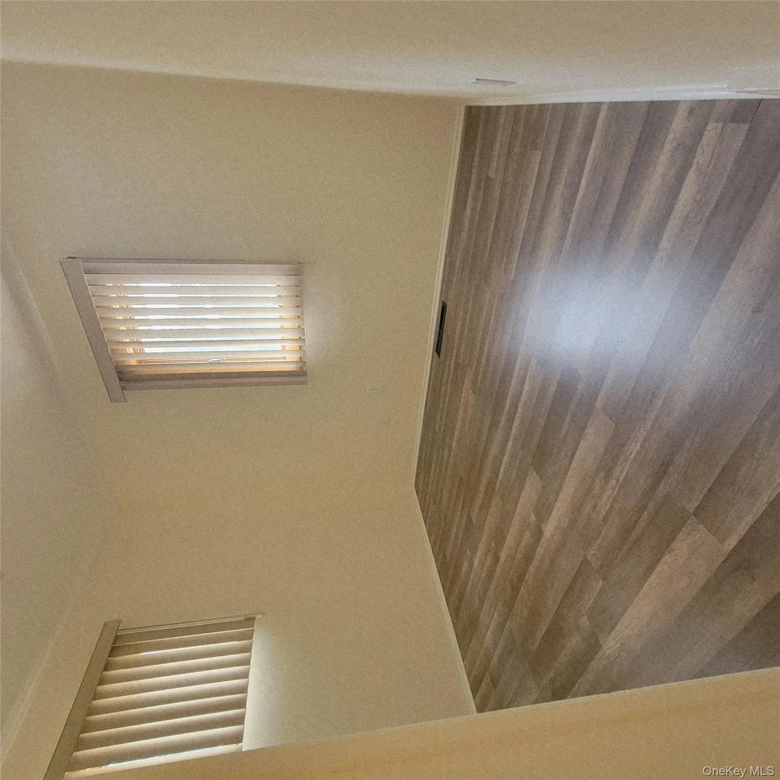 Spare room featuring dark wood-style flooring and baseboards Spare room featuring dark wood-style flooring and baseboards