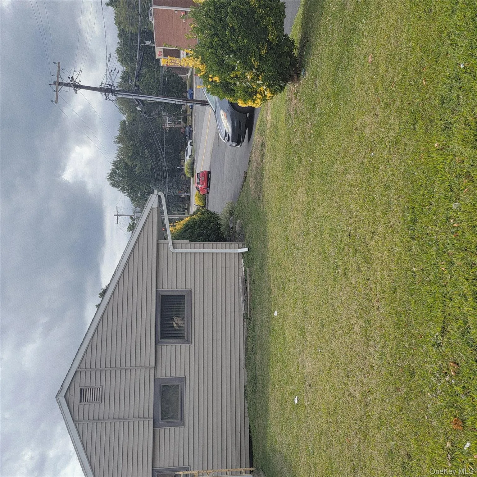 View of home\'s exterior with a yard View of home\'s exterior with a yard