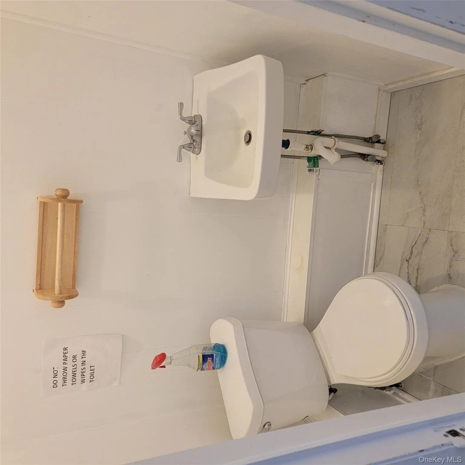 Half bathroom featuring toilet and a sink Half bathroom featuring toilet and a sink