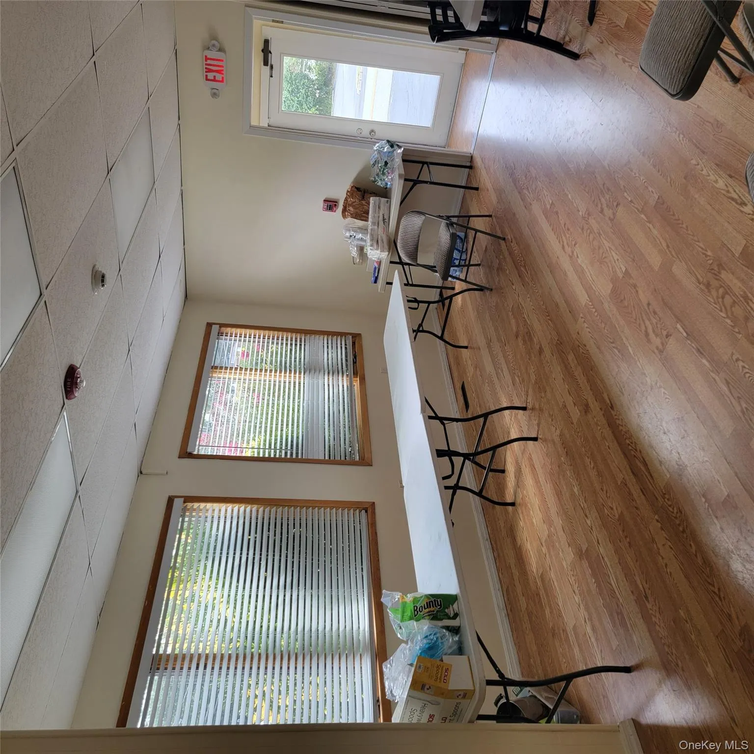 Home office featuring light wood-type flooring and a paneled ceiling Home office featuring light wood-type flooring and a paneled ceiling