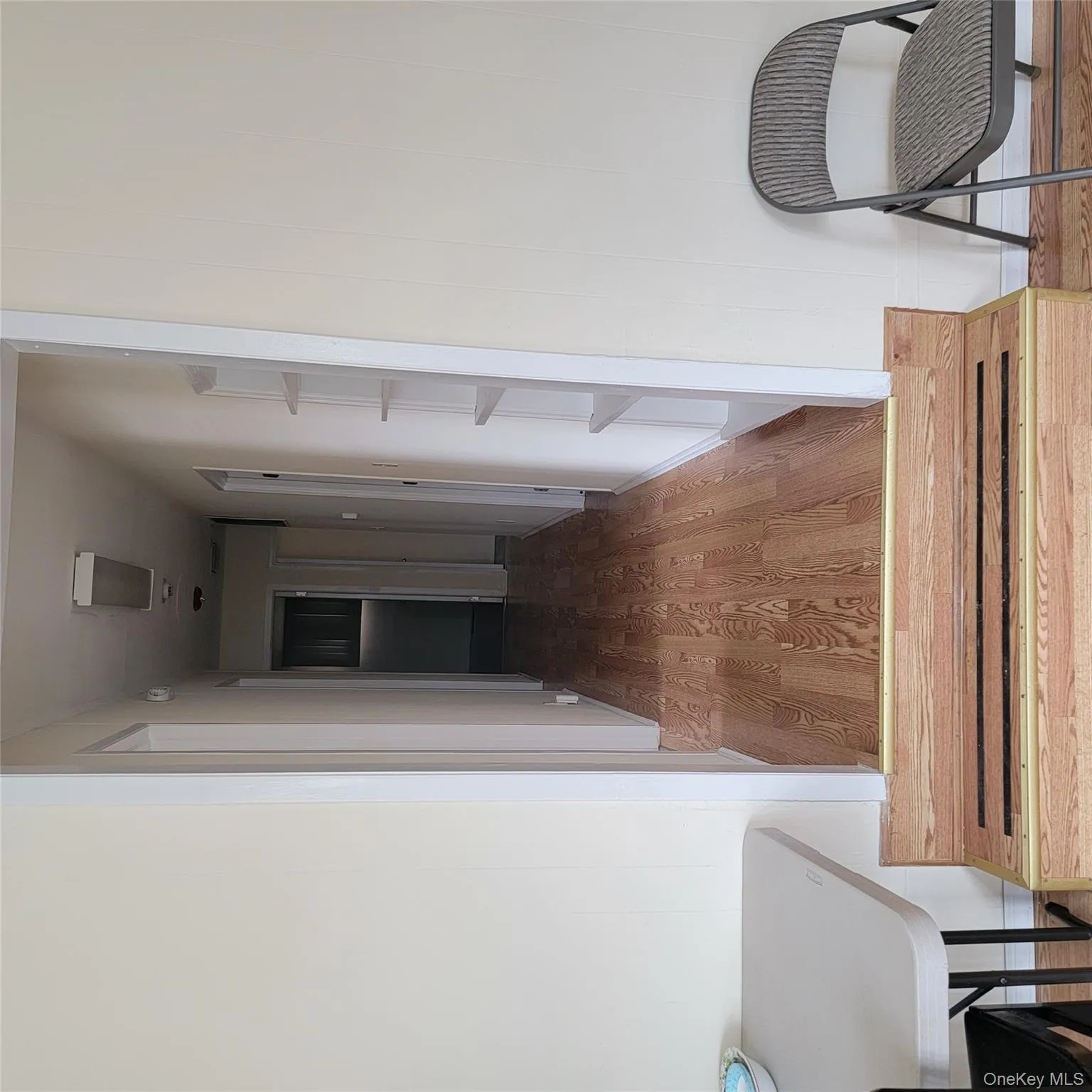 Corridor featuring light wood finished floors and baseboards Corridor featuring light wood finished floors and baseboards