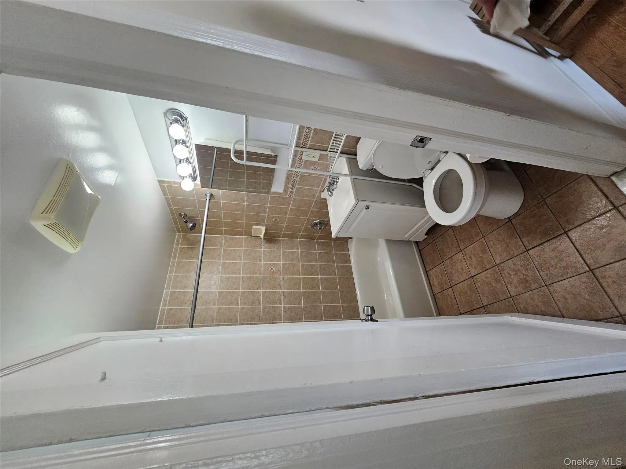 Full bathroom with washtub / shower combination, tile patterned flooring, and vanity Full bathroom with washtub / shower combination, tile patterned flooring, and vanity