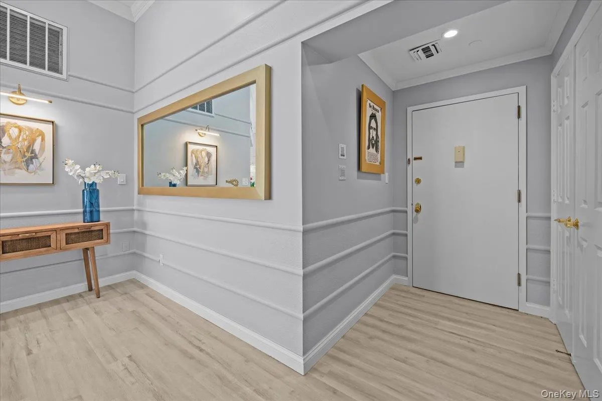 Entrance foyer with crown molding, light wood finished floors, and recessed lighting Entrance foyer with crown molding, light wood finished floors, and recessed lighting