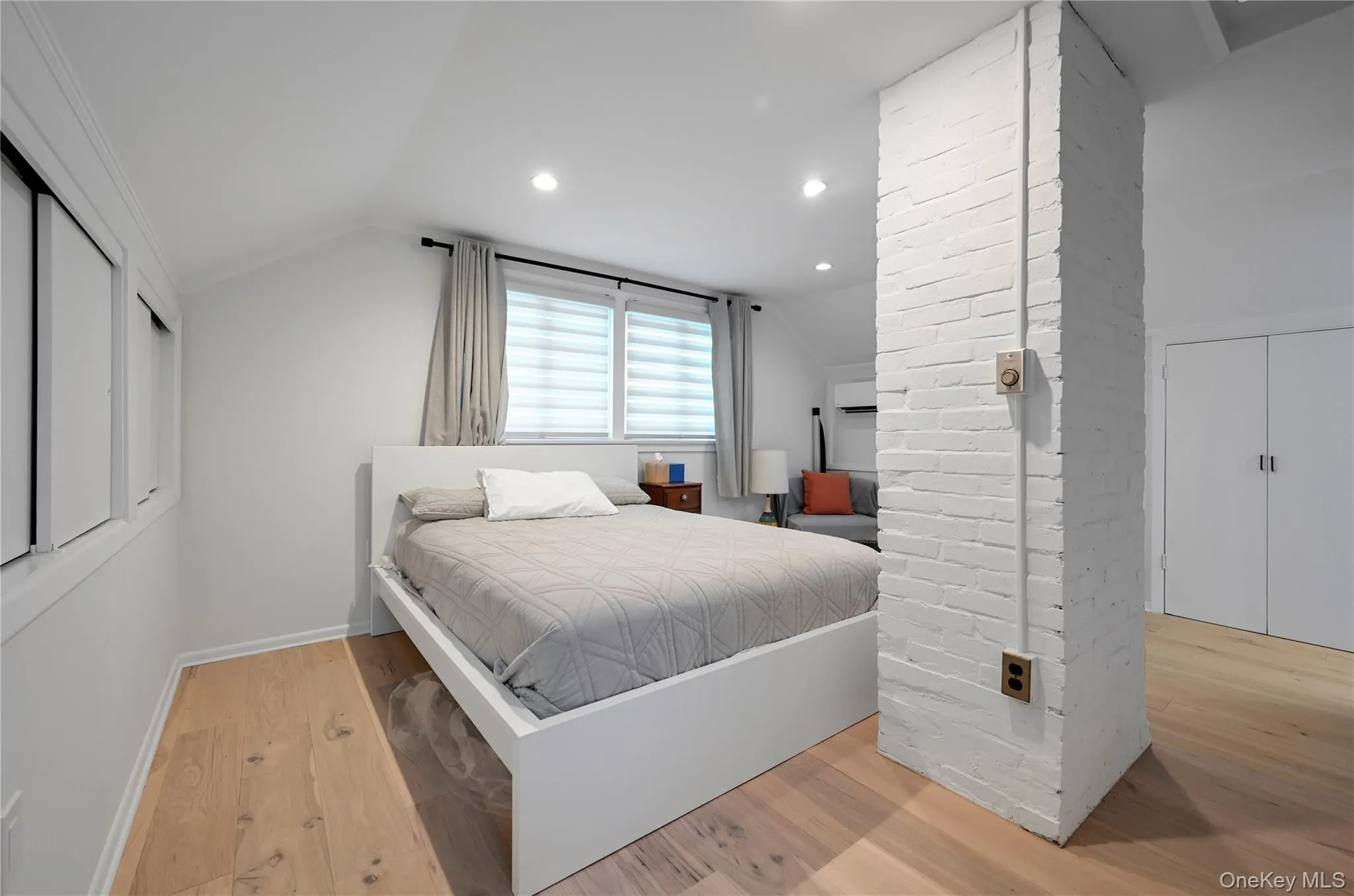 Bedroom featuring vaulted ceiling, light wood-style flooring, and recessed lighting Bedroom featuring vaulted ceiling, light wood-style flooring, and recessed lighting