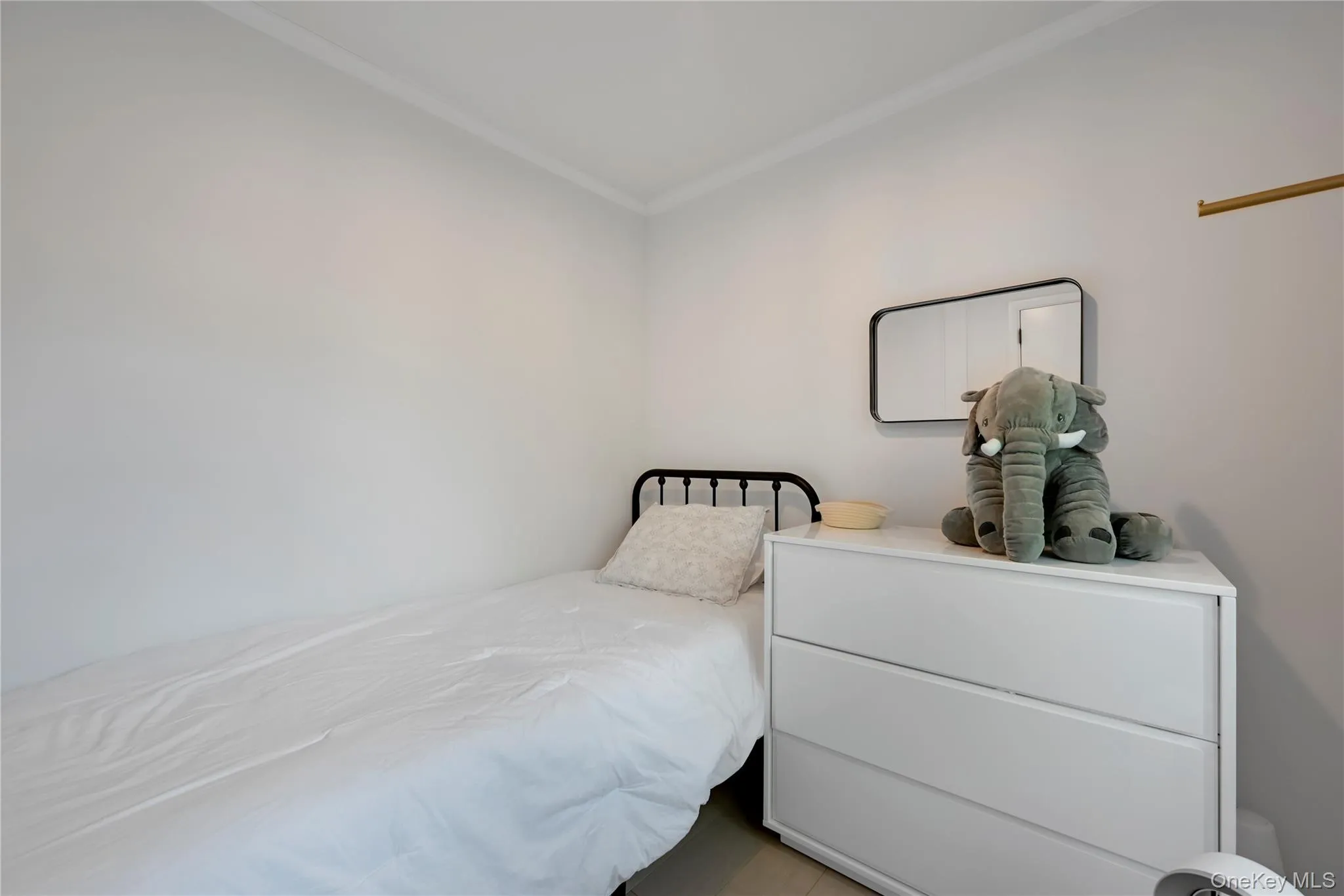 Bedroom featuring ornamental molding Bedroom featuring ornamental molding