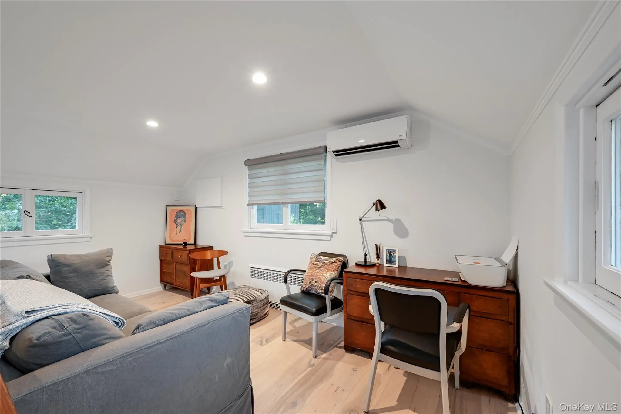 Office area featuring lofted ceiling, plenty of natural light, light wood-style floors, radiator, and recessed lighting Office area featuring lofted ceiling, plenty of natural light, light wood-style floors, radiator, and recessed lighting