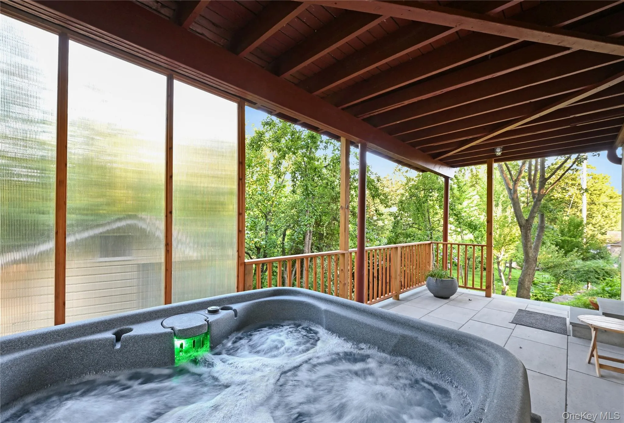 View of patio featuring a hot tub View of patio featuring a hot tub