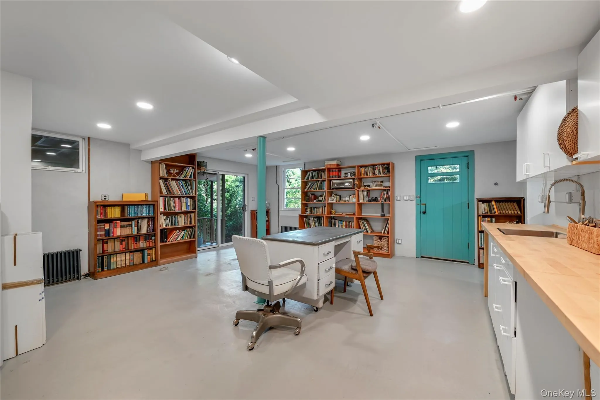 Dining room featuring finished concrete floors, radiator, and recessed lighting Dining room featuring finished concrete floors, radiator, and recessed lighting