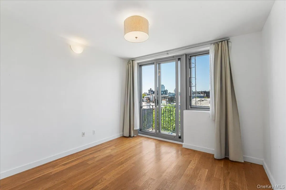 Unfurnished room with light wood-type flooring and a city view Unfurnished room with light wood-type flooring and a city view