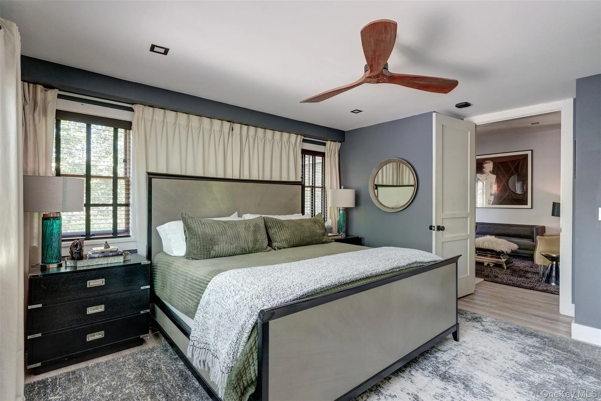 Bedroom with light wood-style flooring and a ceiling fan Bedroom with light wood-style flooring and a ceiling fan