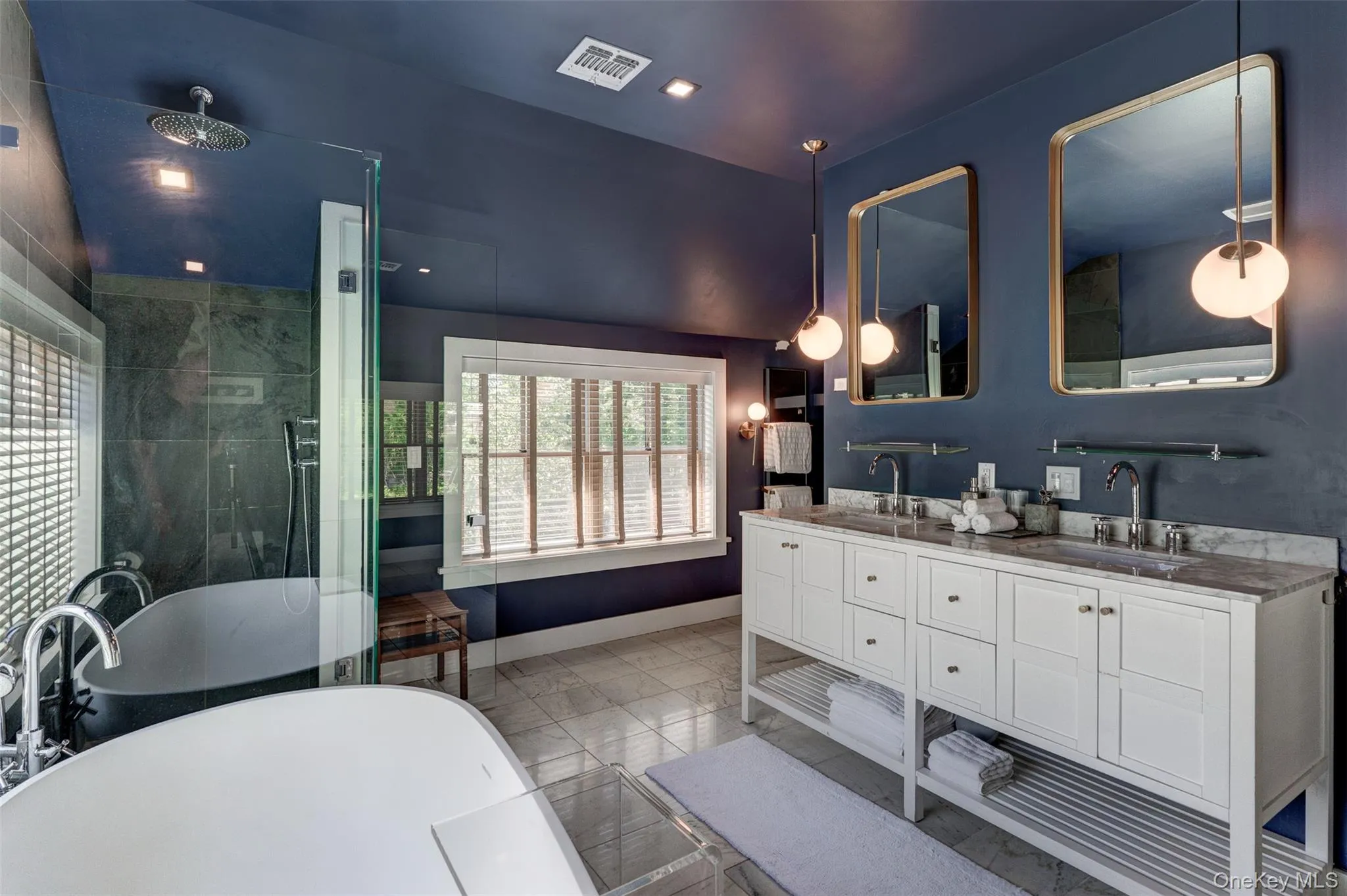 Full bath with a soaking tub, double vanity, a stall shower, vaulted ceiling, and recessed lighting Full bath with a soaking tub, double vanity, a stall shower, vaulted ceiling, and recessed lighting