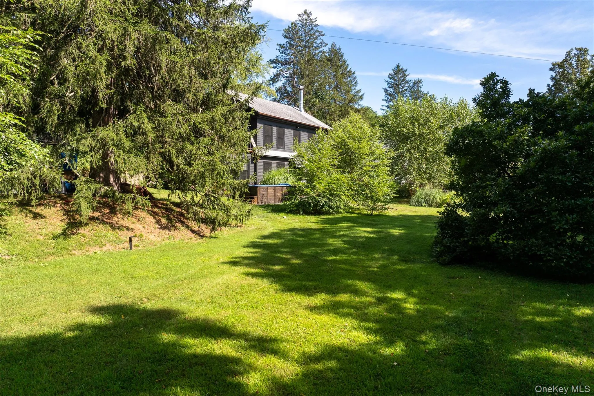 View of green lawn featuring view of scattered trees View of green lawn featuring view of scattered trees