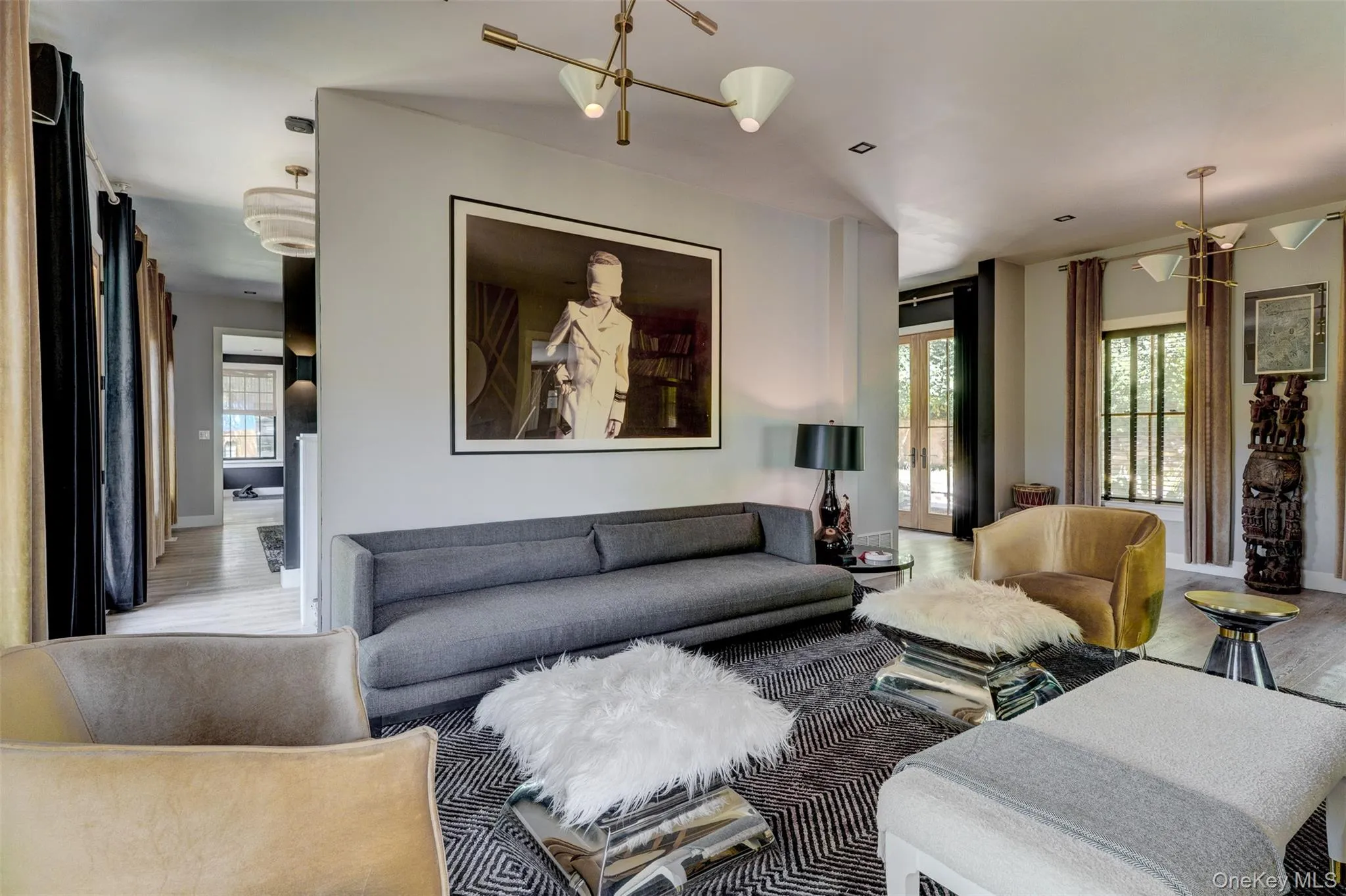 Living room featuring a chandelier, wood finished floors, and french doors Living room featuring a chandelier, wood finished floors, and french doors