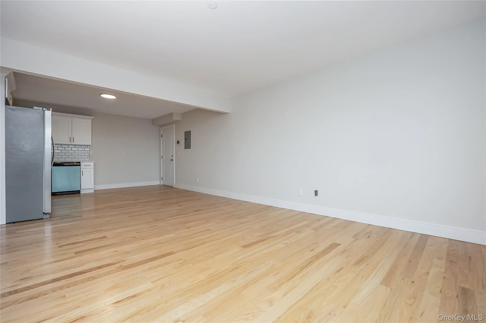 Unfurnished living room featuring light wood-style flooring and recessed lighting Unfurnished living room featuring light wood-style flooring and recessed lighting