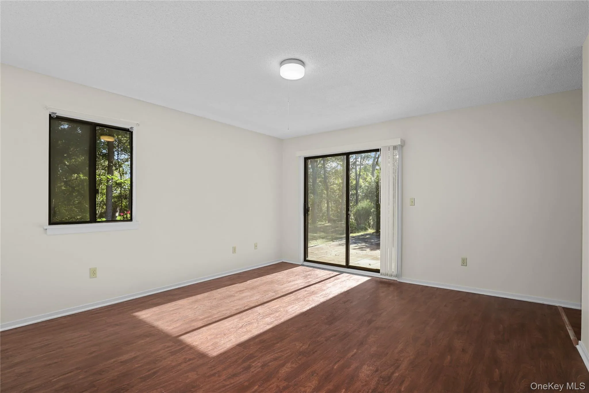 Bedroom with plenty of natural light and sliding doors to the patio Bedroom with plenty of natural light and sliding doors to the patio