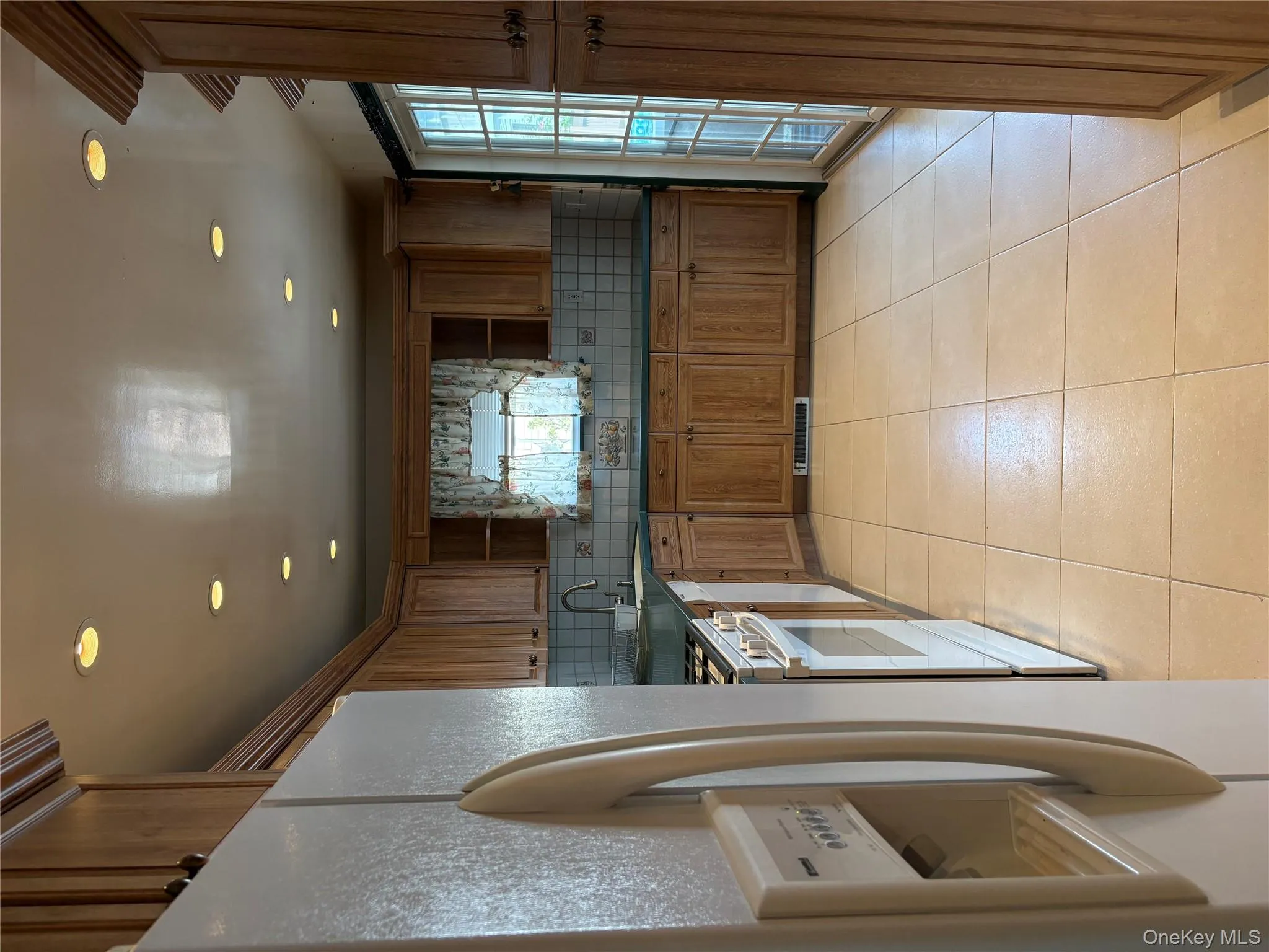 Kitchen with open shelves, fridge, recessed lighting, tasteful backsplash, and dark countertops Kitchen with open shelves, fridge, recessed lighting, tasteful backsplash, and dark countertops