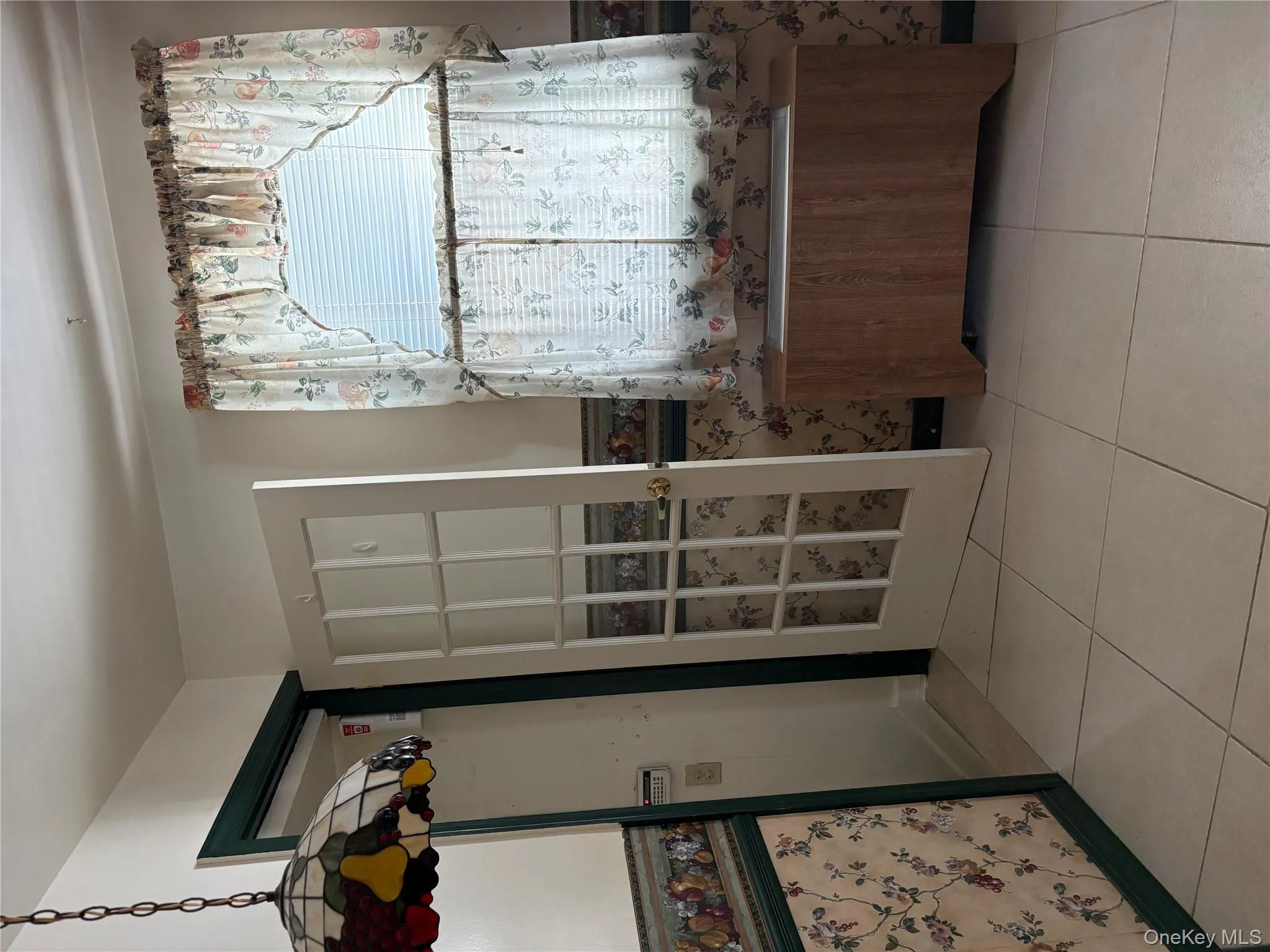 Bathroom with tile patterned flooring and lofted ceiling Bathroom with tile patterned flooring and lofted ceiling