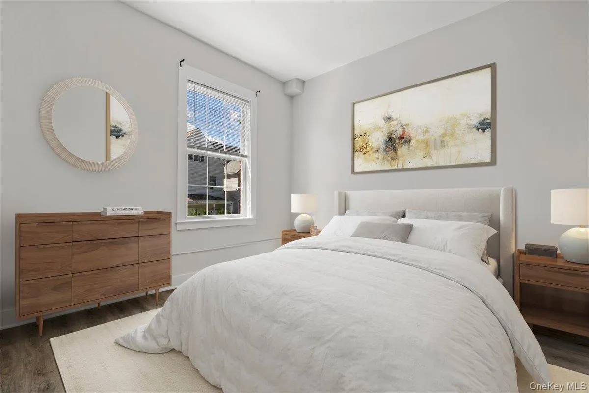 Bedroom featuring wood finished floors and baseboards Bedroom featuring wood finished floors and baseboards
