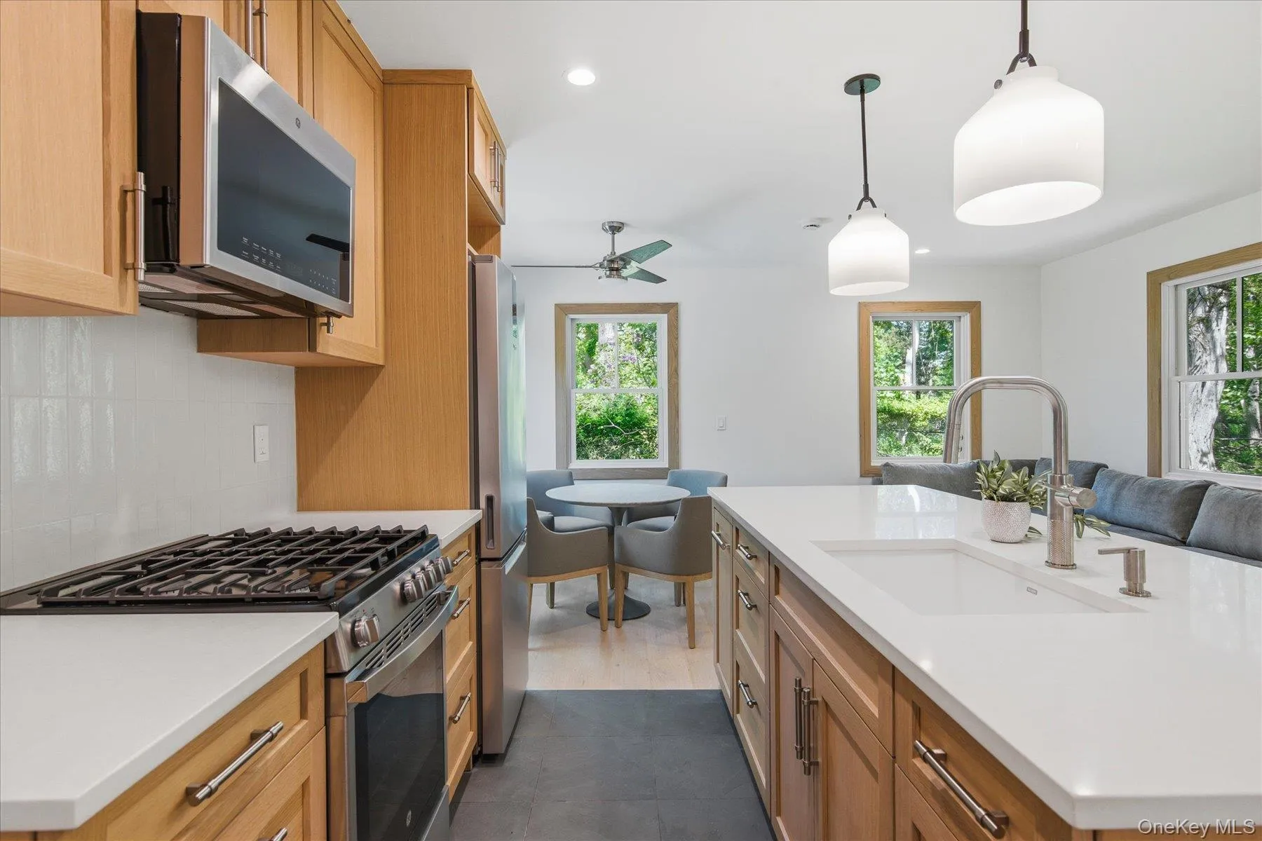 Galley kitchen with oak cabinetry and quartz countertops Galley kitchen with oak cabinetry and quartz countertops